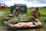 From left, Staff Sgt. Ethan Major evaluates a notional casualty while Sgt. Nate MacDonald provides rescue breaths on a notional casualty during annual training June 6, 2023, at the Berlin Regional Airport.