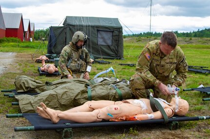 From left, Staff Sgt. Ethan Major evaluates a notional casualty while Sgt. Nate MacDonald provides rescue breaths on a notional casualty during annual training June 6, 2023, at the Berlin Regional Airport.