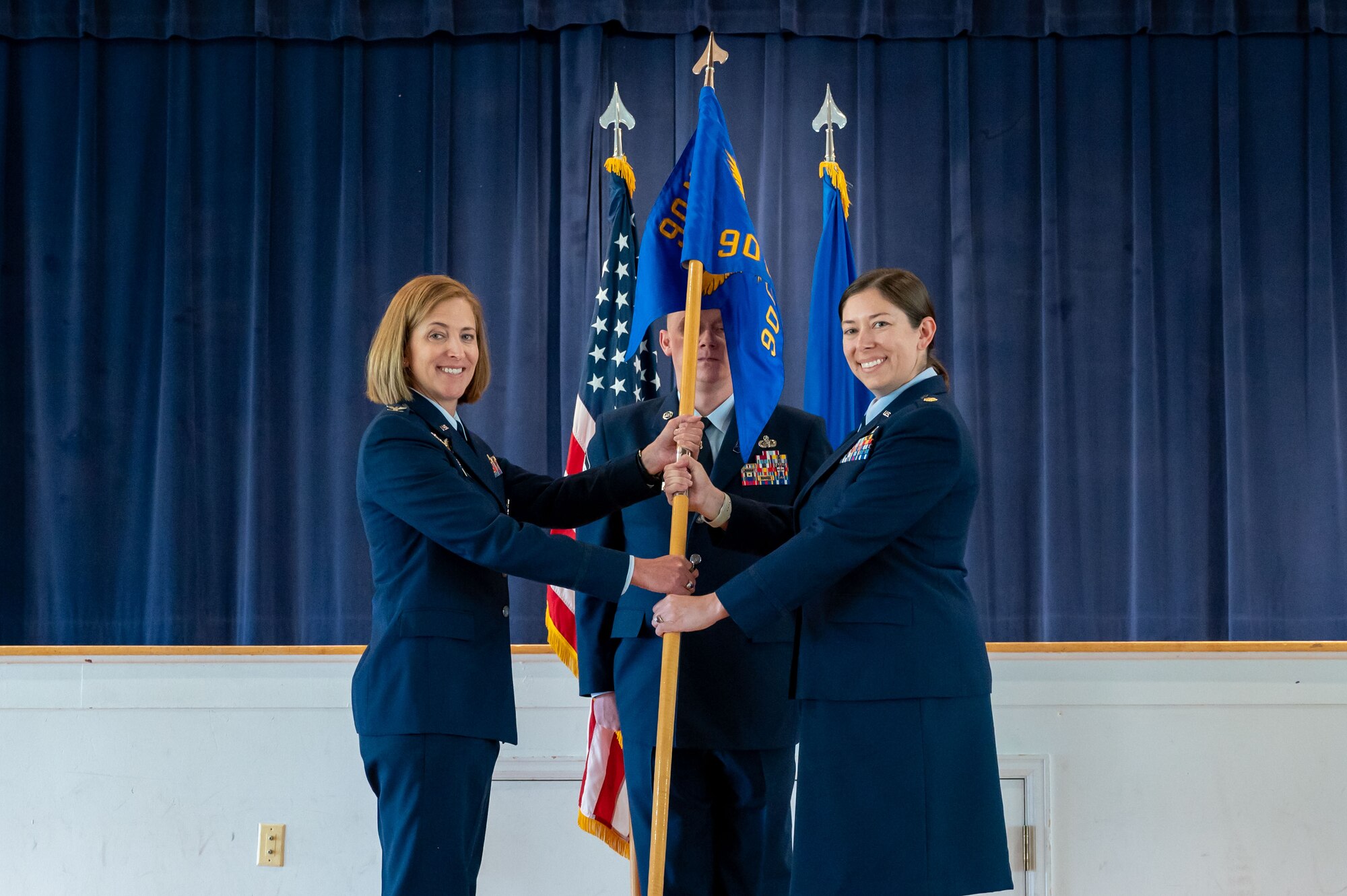 Incoming 90 CPTS commander passes the guidon to the presiding officer.