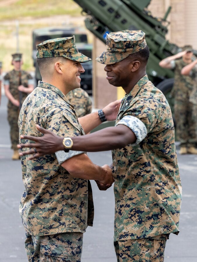 U.S. Marine Corps Lt. Col. McDaniel Sharber, left, outgoing commanding officer of 1st Air Naval Gunfire Liaison Company, and Lt. Col. Thomas Giraldi, incoming commanding officer of 1st ANGLICO, embrace each other during the 1st ANGLICO change of command ceremony, at Marine Corps Base Camp Pendleton, California, June 15, 2023. The ceremony was held to commemorate the passing of command from Lt. Col. McDaniel Sharber to Lt. Col. Thomas Giraldi. (U.S. Marine Corps photo by Sgt. Samuel Fletcher)