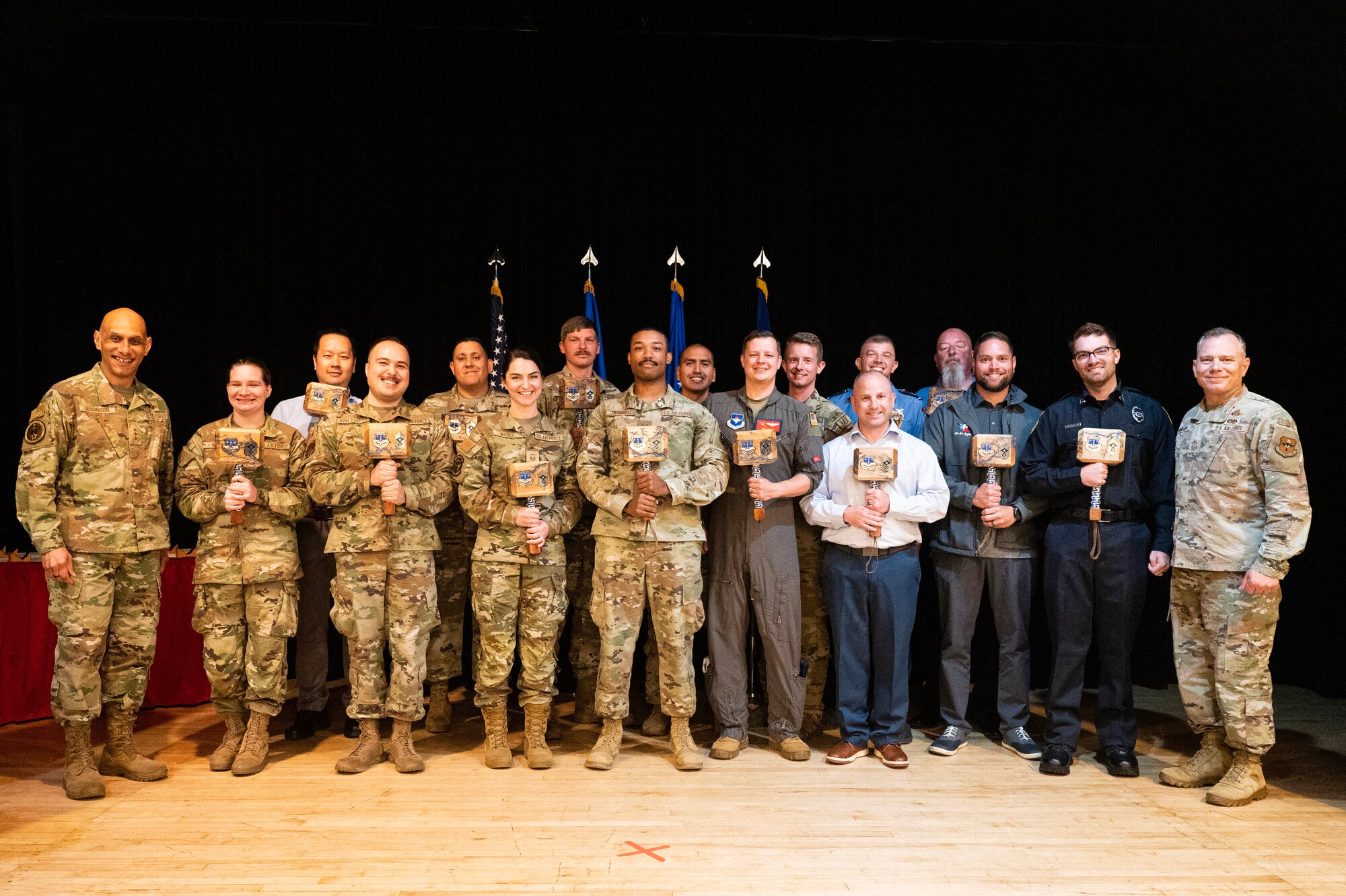 U.S. Air Force Lt. Gen. Brian Robinson, commander of Air Education and Training Command, and Chief Master Sgt. Erik Thompson, command chief of AETC, take a group photo with Airmen selected as the AETC Outstanding Airmen of the Year during a ceremony on Joint Base San Antonio-Randolph, Texas.