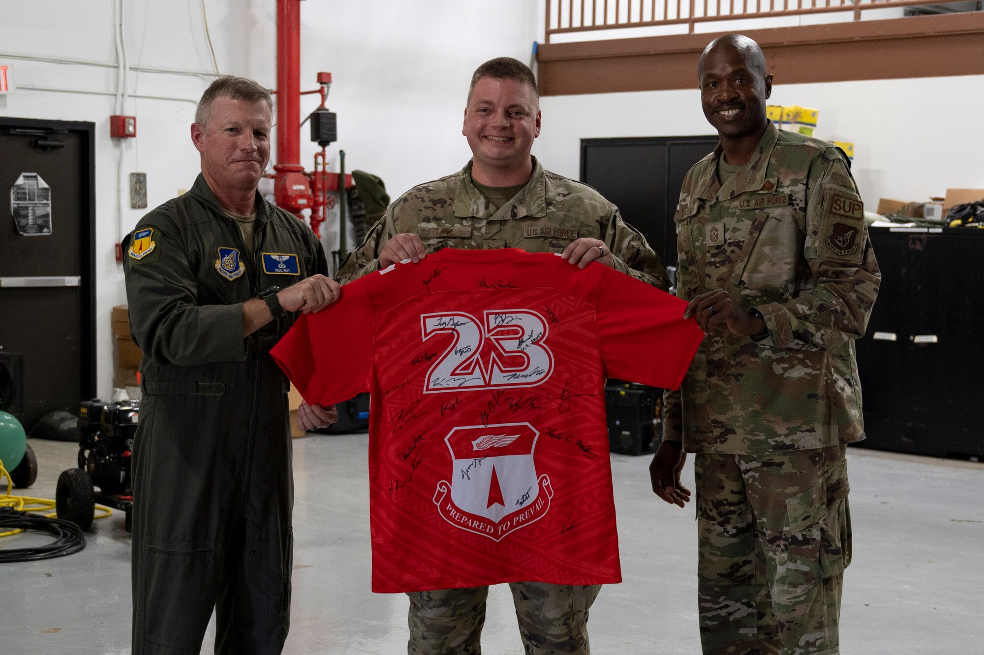 U.S. Air Force Staff Sgt. Lucas Tate, unit training manager assigned to the 36th Contingency Response Squadron, receives the Linebacker of the Week Award from U.S. Air Force Brig. Gen. Paul Fast, commander of the 36th Wing, and U.S. Air Force Chief Master Sgt. Nicholas Taylor, the command chief of the 36th Wing, at Andersen Air Force Base, Guam, June 14, 2023. The Team Andersen Linebacker of the Week recognizes outstanding enlisted, officer, civilian and total force personnel who have had an impact on achieving Team Andersen’s mission, vision and priorities. (U.S. Air Force photo by Airman 1st Class Emily Saxton)