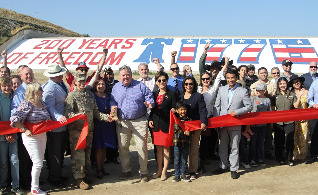 Project partners, elected leaders and community members from throughout the Riverside, San Bernardino and Orange counties gather June 2 to unveil the newly restored bicentennial mural at Prado Dam in Corona, California. Col. Julie Balten, U.S. Army Corps of Engineers Los Angeles District commander, is visible on the left portion of the photograph.