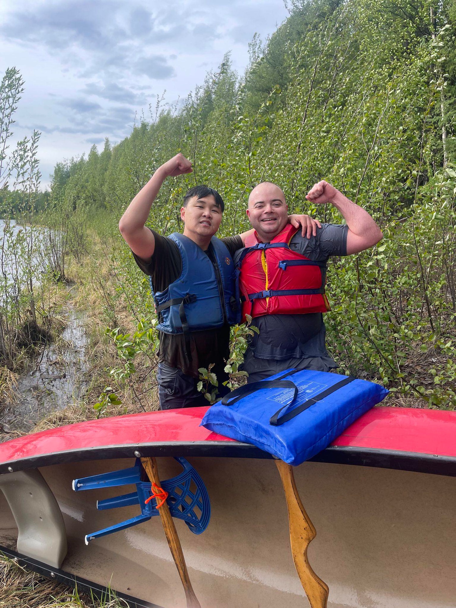 U.S. Air Force Capt. Sung Woo Suh, 80th Fighter Generation Squadron Director of Operations, left,, and Master Sgt.t Carleton Kennedy, 80th FGS production supervisor, pose for a photo at Chena Lake Recreation Area, June 3, 2023. While deployed to Eielson in support of RED FLAG-Alaska, Suh and Kennedy were recognized for saving an infant, father and dog from drowning and hypothermia when their kayak capsized in Chena Lake, Alaska on June 3, 2023. (Courtesy photo)