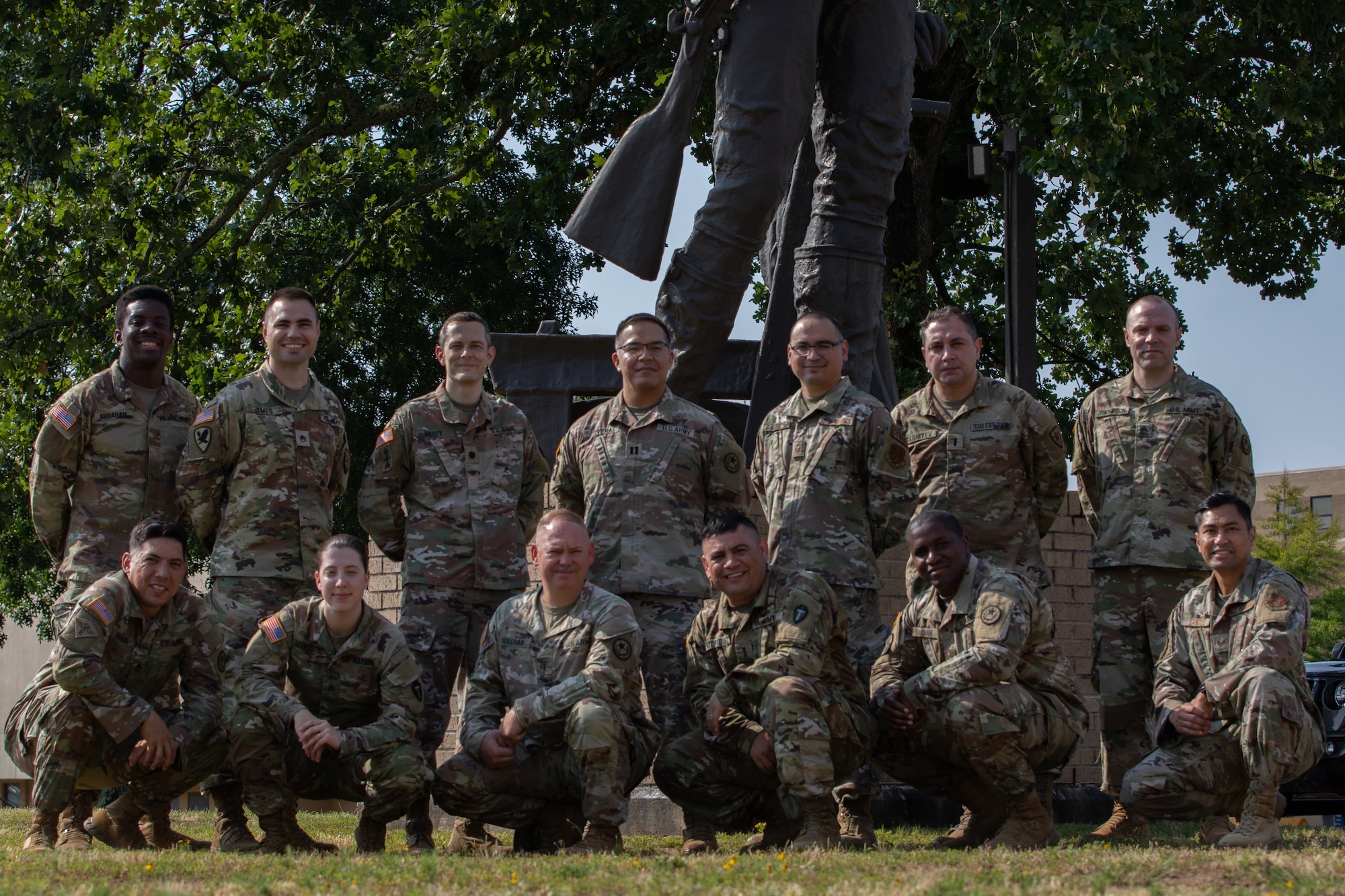 Texas National Guardsmen participating in Cyber Shield 2023 pose for a group photo in front of the Minuteman statue at the Professional Educational Center, Little Rock, Ark., June 8, 2023. Approximately 800 National Guard and Army Reserve Soldiers, Airmen, Sailors, and civilian cyber professionals from around the world attended this year’s Cyber Shield training exercise.