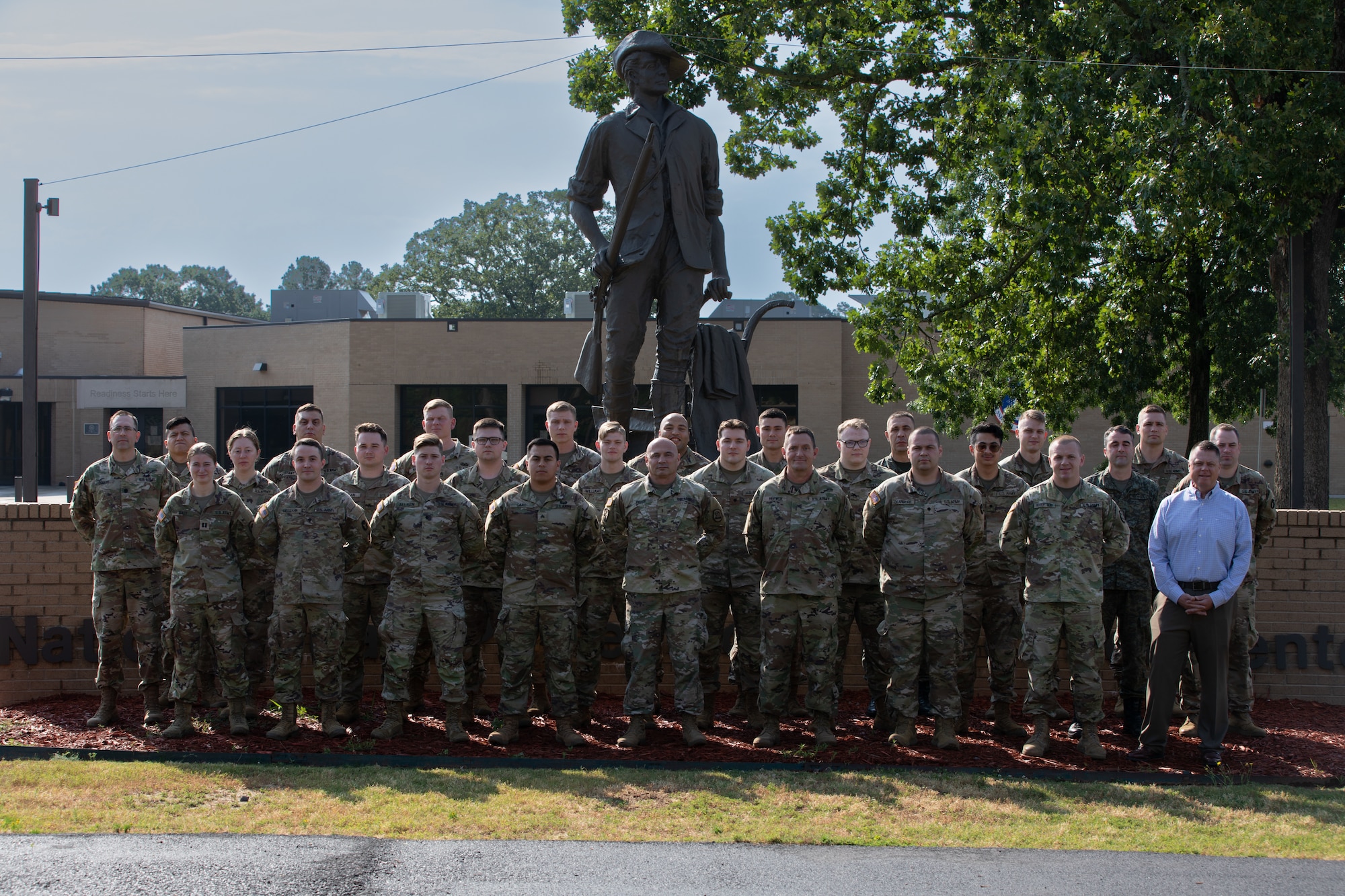 Iowa National Guardsmen participating in Cyber Shield pose with one of their civilian counterparts and one Kosovo soldier from their State Partnership Program in front of the Minuteman statue at The Professional Educational Center, Little Rock, Ark., June 8, 2023. Approximately 800 National Guard and Army Reserve Soldiers, Airmen, Sailors, and civilian cyber professionals from around the world gathered during this year’s Cyber Shield training exercise.