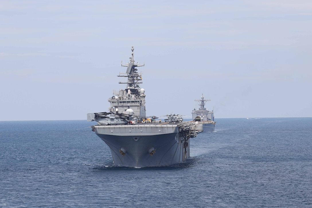 The Wasp-class amphibious assault ship USS Bataan and Harpers Ferry-class dock landing ship USS Carter Hall form a strait transit formation behind the San Antonio-class amphibious transport dock ship USS Mesa Verde during Composite Training Unit Exercise, Atlantic Ocean, May 21, 2023. The strait transit simulated the Wasp-class amphibious assault ship USS Bataan, Harpers Ferry-class dock landing ship USS Cater Hall and Mesa Verde comping into contact with and receiving and returning enemy fire from small boats while in formation. C2X is the last at-sea period of the Pre-deployment Training Program for the Bataan Amphibious Ready Group.