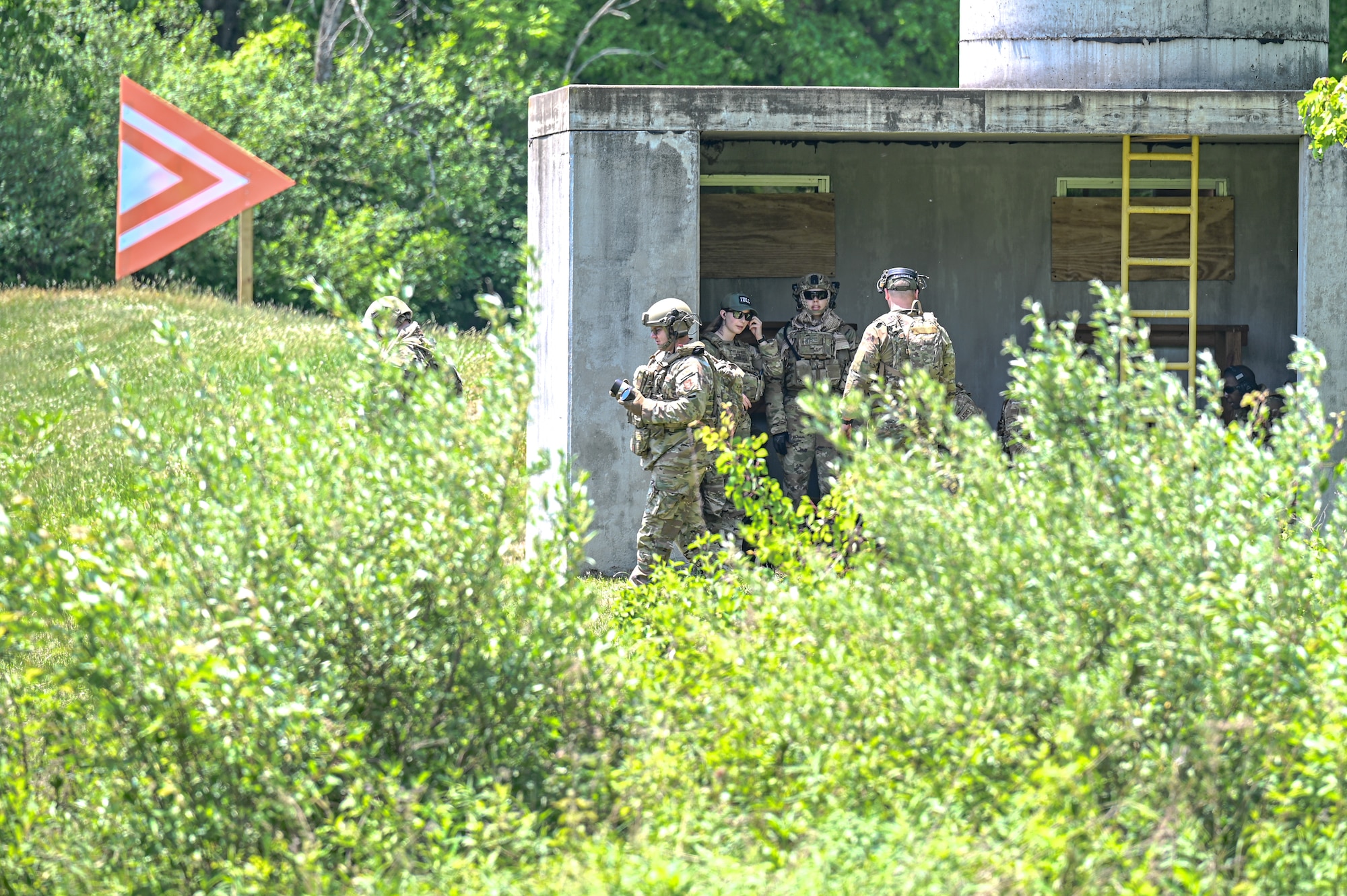 Tech. Sgt. Allen Russell, an Integrated Defense Leadership Course cadre member assigned to the 910th Security Forces Squadron, Youngstown Air Reserve Station, Ohio, carries two live grenades to detonate on May 31, 2023, at Camp James A. Garfield Joint Military Training Center, Ohio.