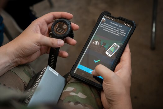  A Guardian syncs data from a wearable device to a phone during a Continuous Fitness Assessment, or CFA, study informational session hosted by an Air Force Research Laboratory team at a facility near Wright-Patterson Air Force Base, Ohio, June 8, 2023. The CFA study is a two-year voluntary effort with Guardians to assess the use of wearable fitness devices that measure physical activity. The CFA is part of the U.S. Space Force’s Holistic Health Approach, an initiative that promotes wellness through positive behaviors and seeks to replace traditional military fitness tests with data from continuous monitoring technology. (U.S. Space Force photo / Rick Eldridge).