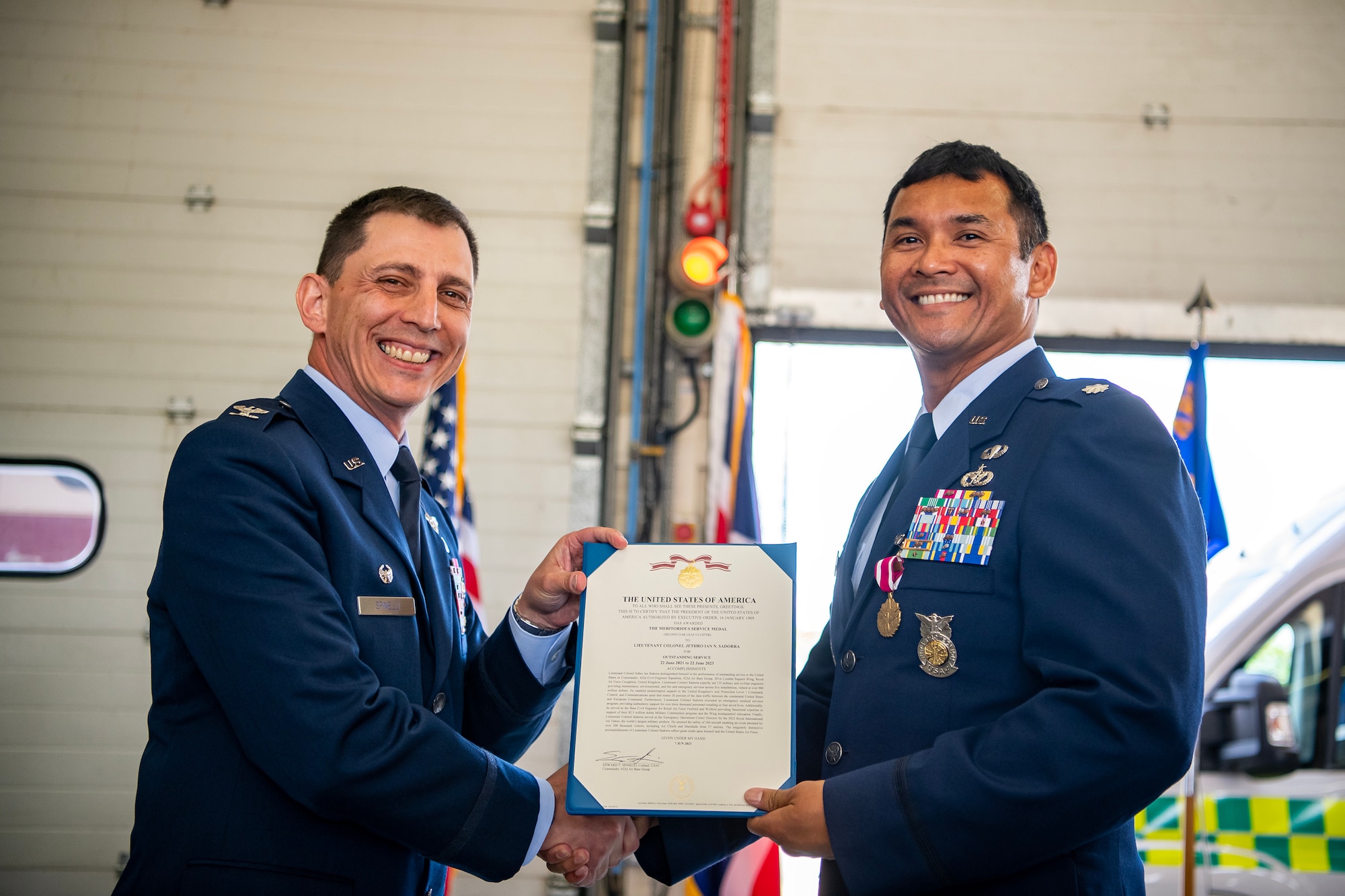 U.S. Air Force Col. Edward Spinelli, left, 422d Air Base Group commander, presents a Meritorious Service Medal decoration to Lt. Col. Jethro Sadora, 422d Civil Engineer Squadron outgoing commander at RAF Croughton, England, June 15, 2023. During his command, Saddora led 155 personnel and was responsible for the construction, maintenance, fire prevention and environmental protection for real property and infrastructure encompassing 787 facilities, spanning 1,205 acres valued at one billion dollars. (U.S. Air Force photo by Staff Sgt. Eugene Oliver)