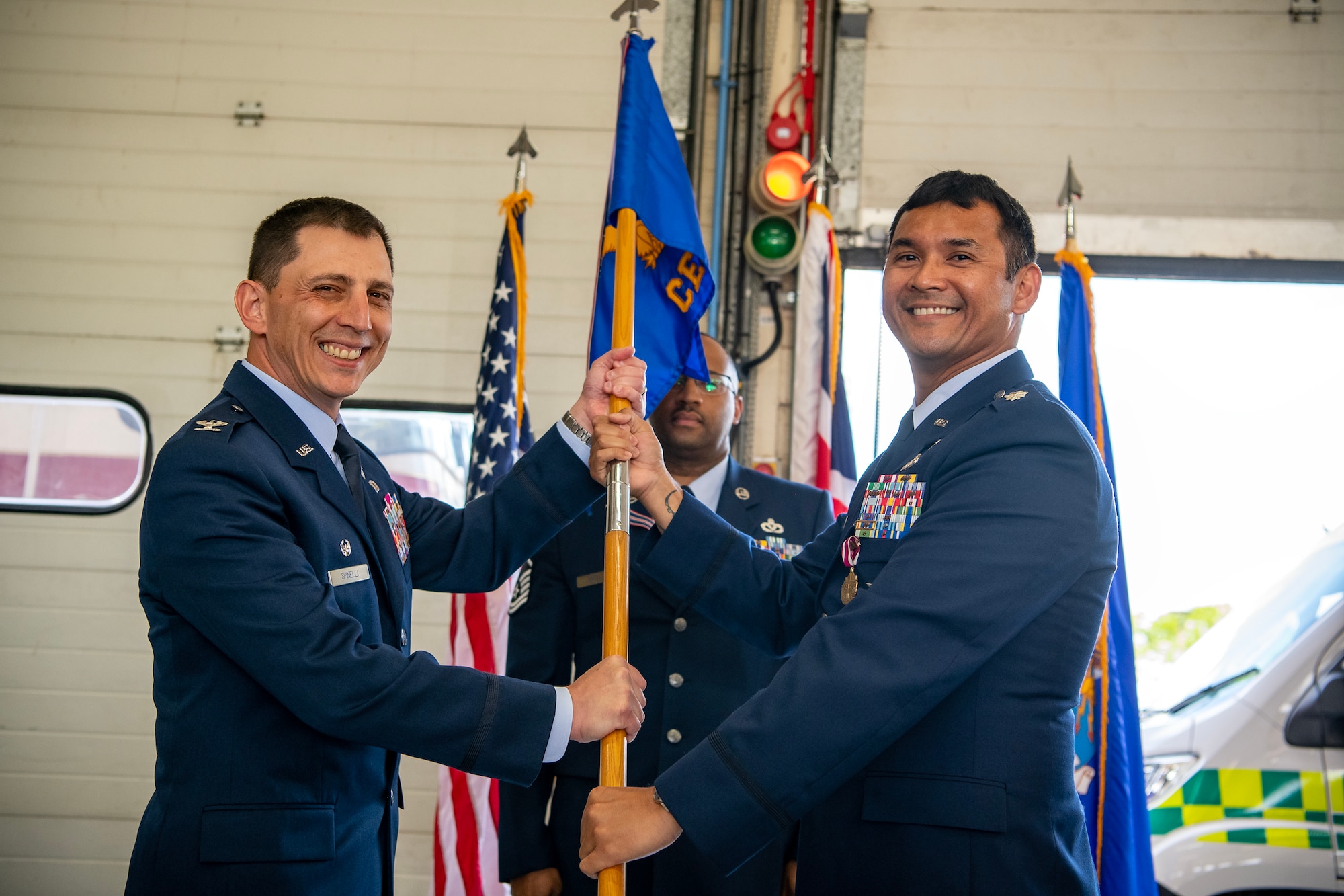 U.S. Air Force Col. Edward Spinelli, left,  422d Air Base Group commander, receives the 422d Civil Engineer Squadron guidon from Lt. Col. Jethro Sadora, 422d CES outgoing commander, during a change of command ceremony at RAF Croughton, England, June 15, 2023. During his command, Saddora led 155 personnel and was responsible for the construction, maintenance, fire prevention and environmental protection for real property and infrastructure encompassing 787 facilities, spanning 1,205 acres valued at one billion dollars. (U.S. Air Force photo by Staff Sgt. Eugene Oliver)