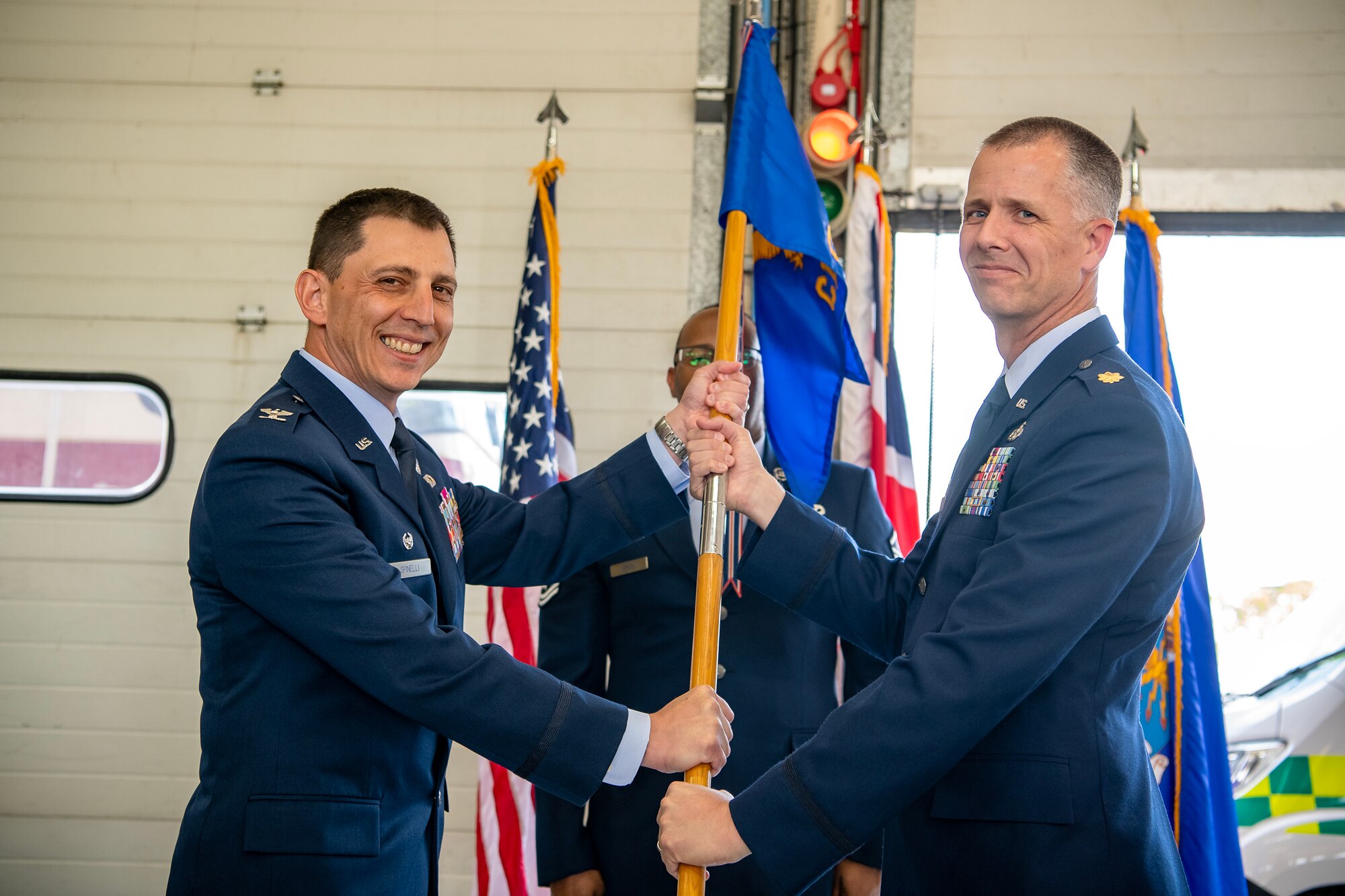 U.S. Air Force Col. Edward Spinelli, left,  422d Air Base Group commander, presents the 422d Civil Engineer Squadron guidon to Maj. Kirk Hull, 422d CES incoming commander, during a change of command ceremony at RAF Croughton, England, June 15, 2023. Prior to assuming command, Hull served as the commander of the Programs and Evaluations Flight at the 554th RED HORSE Squadron, Andersen AFB, Guam. (U.S. Air Force photo by Staff Sgt. Eugene Oliver)