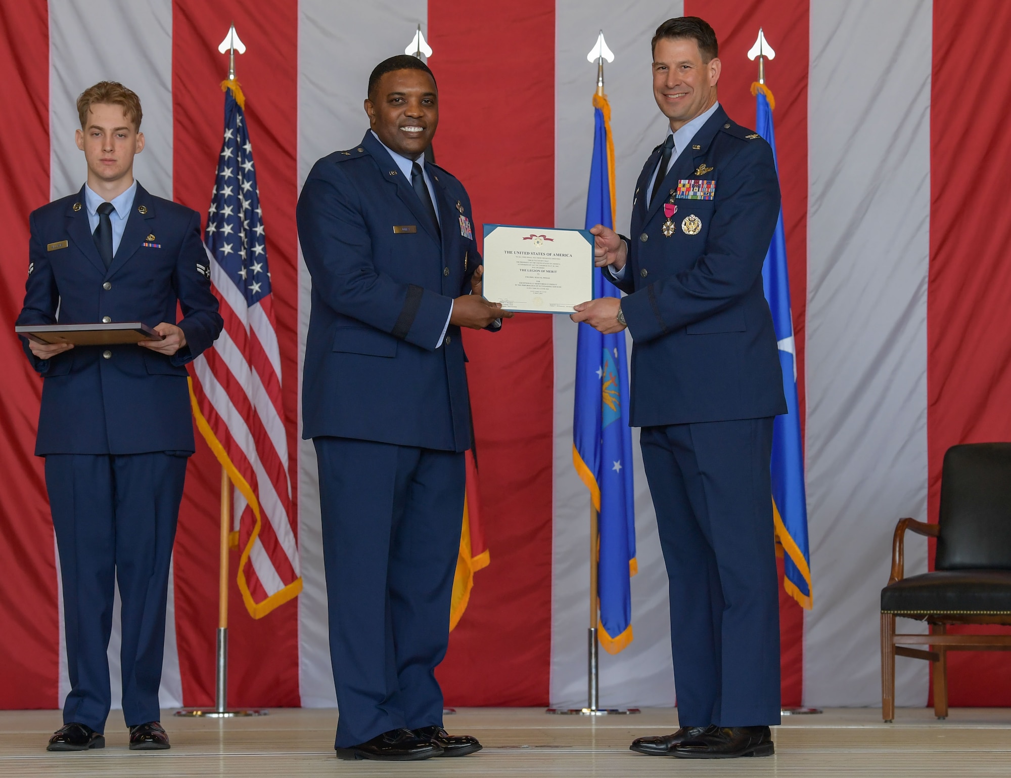 U.S. Air Force Brig. Gen. Otis C. Jones, 86th Airlift Wing commander, left, presents Col. Sean Finnan, 86th Operations Group out-going commander, right, with the legion of merit medal during the 86th OG change of command ceremony at Ramstein Air Base, Germany, June 15, 2023. Finnan received the medal for meritorious service during his time as the 86th OG commander. (U.S. Air Force photo by Airman Trevor Calvert)