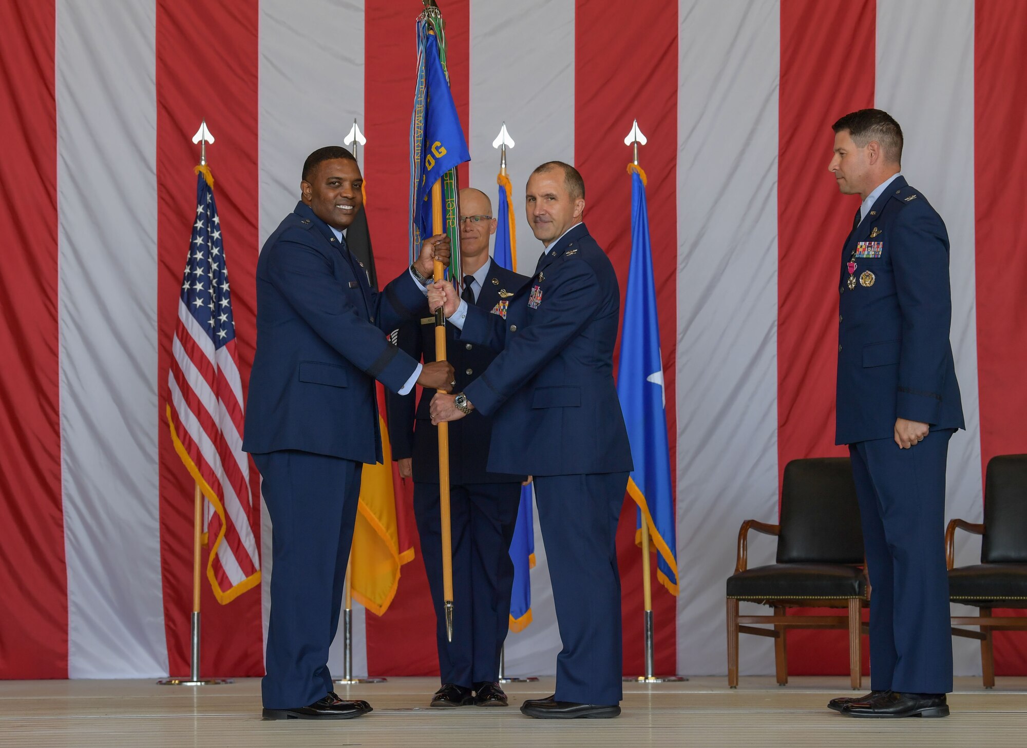 U.S. Air Force Brig. Gen. Otis C. Jones, 86th Airlift Wing commander, left, passes the 86th Operations Group guidon to Col. Bret Echard, 86th OG in-coming commander, middle, during the 86th OG change of command ceremony at Ramstein Air Base, Germany, June 15, 2023. The operations group consists of 14 C-130J Super Hercules aircraft, five C-21A Learjets aircraft and one C-37A Gulfstream V aircraft. (U.S. Air Force photo by Airman Trevor Calvert)