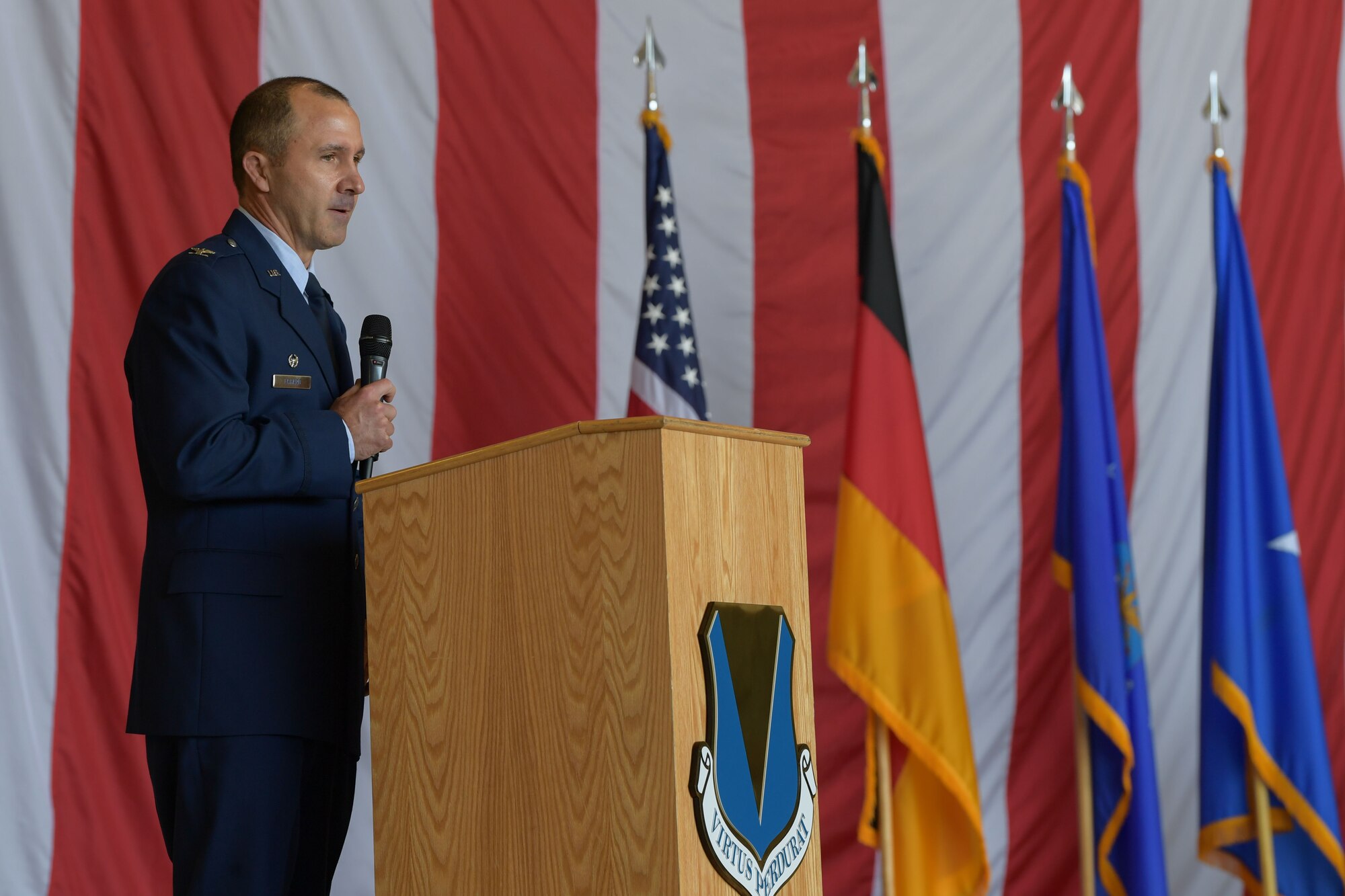 U.S. Air Force Col. Bret Echard, 86th Operations Group in-coming commander, gives a speech after accepting command during the 86th OG change of command ceremony at Ramstein Air Base, Germany, June 15, 2023. Echard was previously the 41st Airlift Squadron commander at Little Rock Air Force Base, Arkansas. (U.S. Air Force  photo by Airman Trevor Calvert)