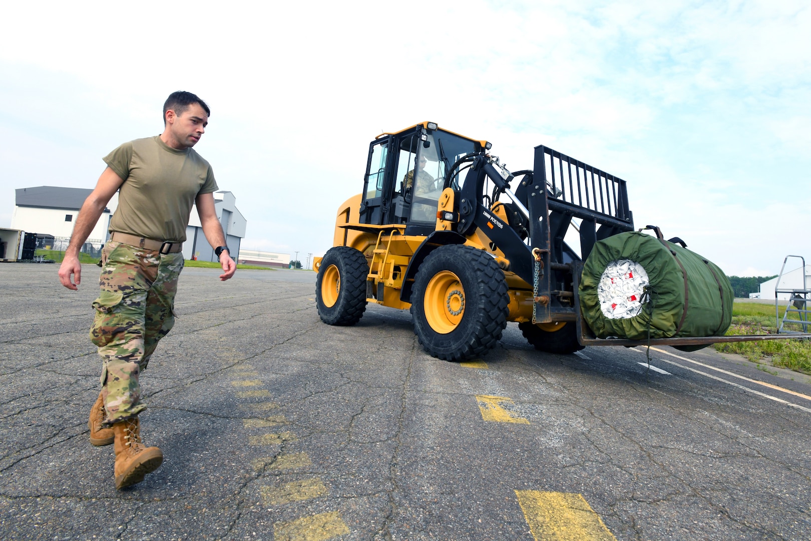 Staff Sgt. Christopher Jones, a radio frequency transmission specialist with the Florida Air National Guard’s 114th Electromagnetic Warfare Squadron, walks with a tractor carrying base shelter equipment as part of exercise ThunderMoose, June 13, 2023, at Bangor Air National Guard Base in Maine. The National Guard provides 60 percent of space electromagnetic warfare capability to the Space Force’s Space Operations Command.