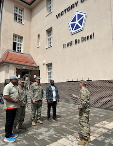 Lt. Col. Eugene Chu, the 405th Army Field Support Brigade’s Corps Logistics Support Element senior representative, briefs representatives from the U.S. Navy and the Defense Logistics Agency outside the V Corps headquarters in Poznan, Poland, June 21. The CLSE serves as a strategic liaison among the U.S. Army Materiel Command enterprise, Department of Defense agencies, the 405th AFSB and V Corps. (U.S. Army courtesy photo)