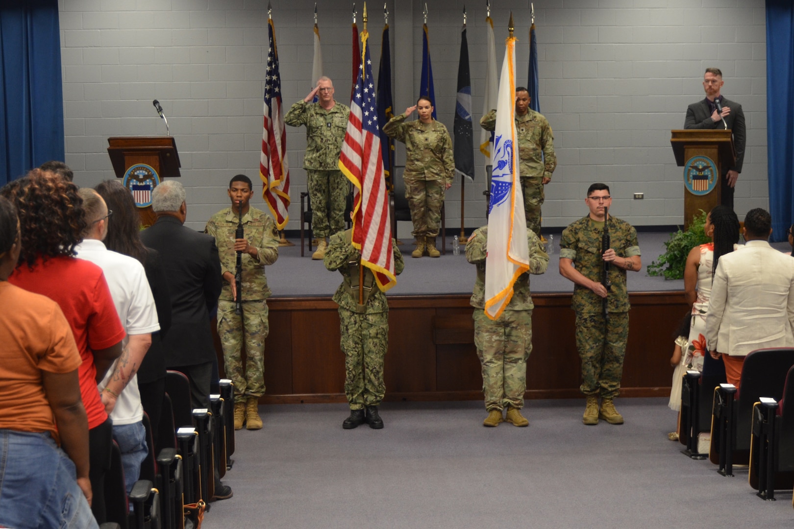 Military and civilian personnel at a change of command ceremony.