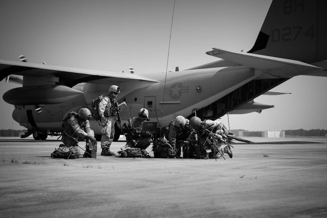 U.S. Marines with 2d Battalion, 10th Marine Regiment, 2d Marine Division set up communications with a M142 High Mobility Artillery Rocket Systems vehicle (HIMARS), after exiting a U.S. Marine Corps C-130 with Marine Aerial Refueler Transport Squadron 252 during a HIMARS rapid infiltration in support of Rolling Thunder 23-2 in Pope Airfield on Fort Bragg, North Carolina, June 9, 2023. Rolling Thunder was a live-fire artillery event that tested the 10th Marine Regiment’s ability to operate in an isolated environment against a peer threat in a dynamic and multi-domain scenario. (U.S. Marine Corps photo illustration by Cpl. Ethan Robert Jones)
