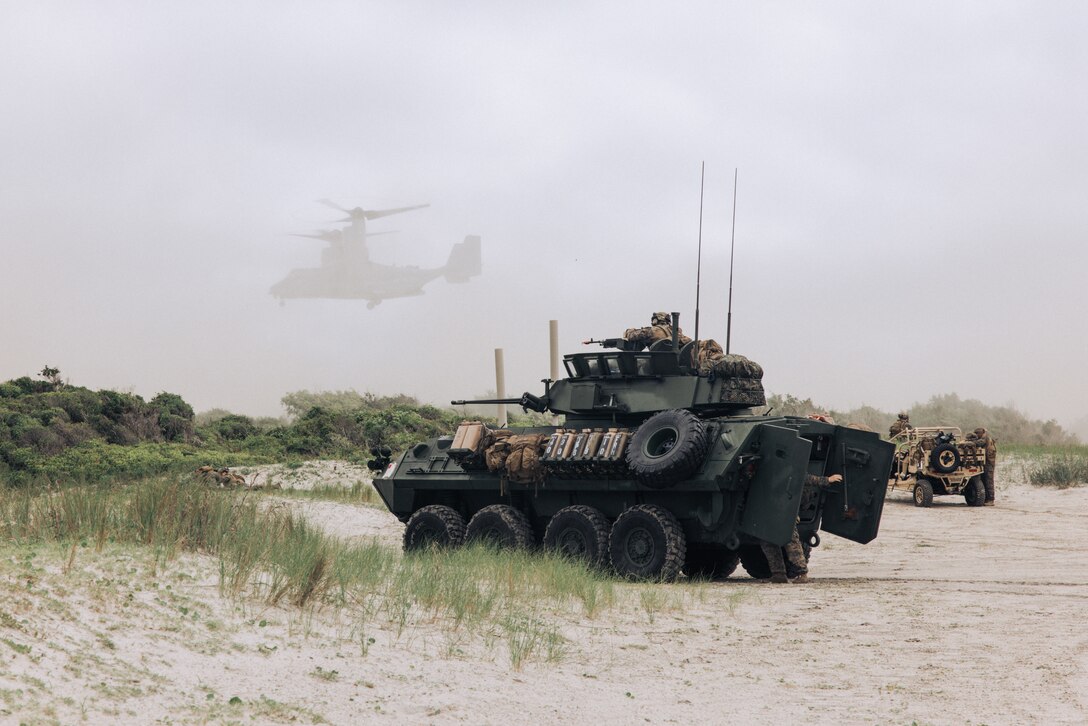 A U.S. Marine Corps Light Armored Vehicle with the 26th Marine Expeditionary Unit provides security for aerial insertion while executing an amphibious assault during Composite Training Unit Exercise (C2X) on Marine Corps Base Camp Lejeune, North Carolina, June 2, 2023. The amphibious assault rehearsed the utilization of Marines to move from ship to shore and secure objectives for follow-on actions. C2X is the last exercise in the pre-deployment training program for the Bataan Amphibious Ready Group. (U.S. Marine Corps photo by Cpl. Kyle Jia)