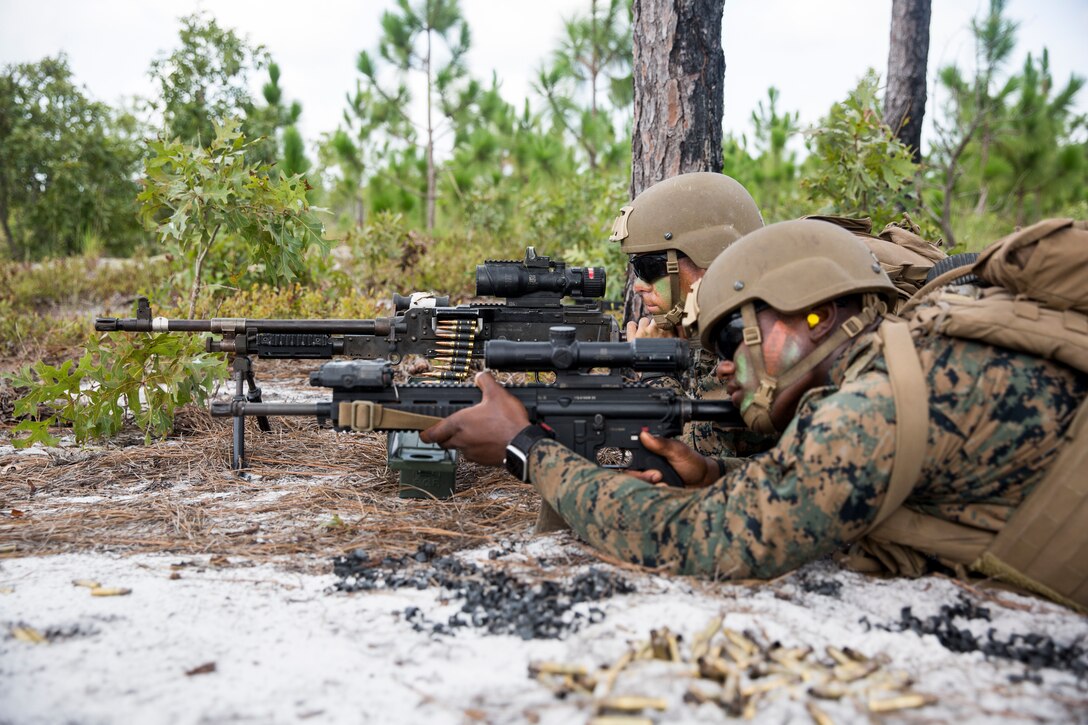 U.S. Marines Pfc. Matthew Haynesworth, foreground, a native of Cleveland, Ohio, and Pfc. Michael Hansen, background, a native of Mahwah, New Jersey, students with Echo Company, School of Infantry East, engage their targets during the Infantry Marine Course, at Range 30, on Marine Corps Base Camp Lejeune, North Carolina, Aug. 27, 2021. The IMC is a 14-week program of instruction designed to modernize infantry training by improving efficiency and lethality. (U.S. Marine Corps photo by Cpl. Christian Ayers)