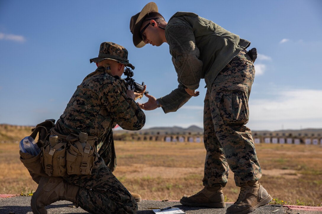 A U.S. Marine Corps marksmanship instructor, with Weapons Field Training Battalion, instructs a recruit with Hotel Company, 2nd Recruit Training Battalion, during the table one course of fire at Marine Corps Base Camp Pendleton, Calif., June 20, 2023. Table one covered the basic fundamentals of marksmanship and rifle safety in all shooting positions sitting, kneeling, and prone. (U.S. Marine Corps photo by Lance Cpl.  Alvarez)