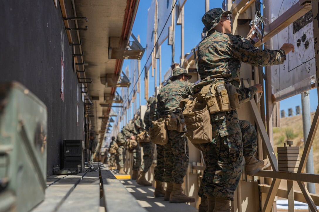 U.S. Marine Corps recruits with Hotel Company, 2nd Recruit Training Battalion, pull and mark targets during the table one course of fire at Marine Corps Base Camp Pendleton, Calif., June 20, 2023. Table one covered the basic fundamentals of marksmanship and rifle safety in all shooting positions sitting, kneeling, and prone. (U.S. Marine Corps photo by Lance Cpl. Alvarez)