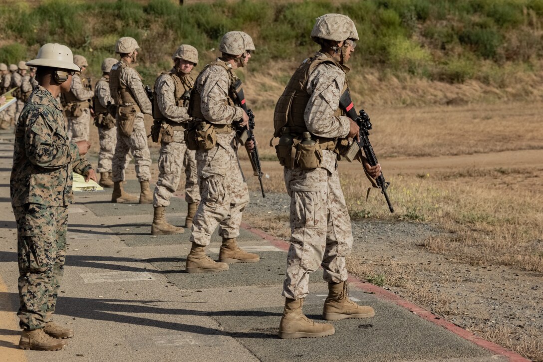 U.S. Marine Corps Recruits with Delta Company 1st Recruit Training Battalion, wait on the firing line before the table two course of fire at Marine Corps Base Camp Pendleton, Calif., June 20, 2023. Table two course of fire teaches recruits the fundamentals of safety and marksmanship in combat shooting positions and rifle carries. (U.S. Marine Corps photo by Lance Cpl. Hutchinson)