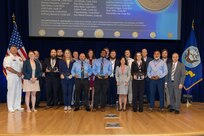 Naval Surface Warfare Center, Carderock Division's Commanding Officer Capt. Matthew Tardy (left), Technical Director Larry Tarasek (right) present the Vice Adm. Emory S. Land Award for Collaboration Excellence to Carderock's Lunch Break Team during Carderock's Magnificent Eight Award ceremony in West Bethesda, Md., on June 13. (U.S. Navy photo by Aaron Thomas)