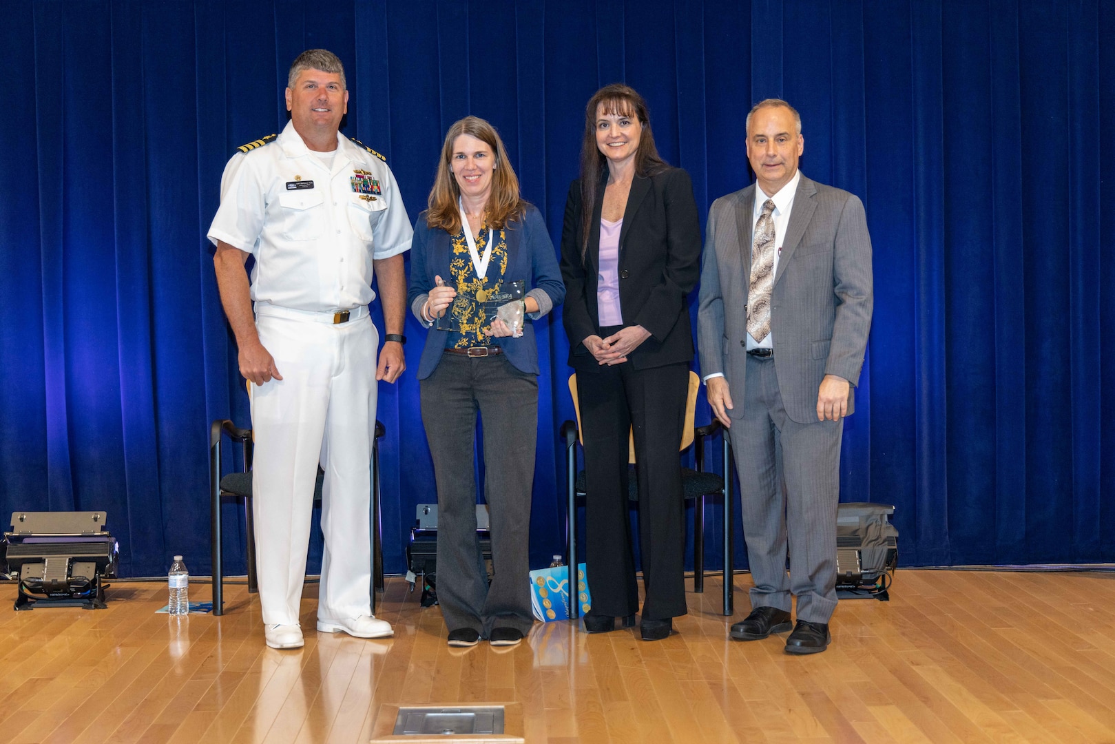Naval Surface Warfare Center, Carderock Division's Commanding Officer Capt. Matthew Tardy (left), Technical Director Larry Tarasek (right) and Tamar Gallagher (second to right), the Corporate Operations Department Head, present the Rear Adm. Grace M. Hopper Award for Excellence in Organizational Support to Executive Assistant Jessica Williamson (second to left) during Carderock's Magnificent Eight Award ceremony in West Bethesda, Md., on June 13. (U.S. Navy photo by Aaron Thomas)