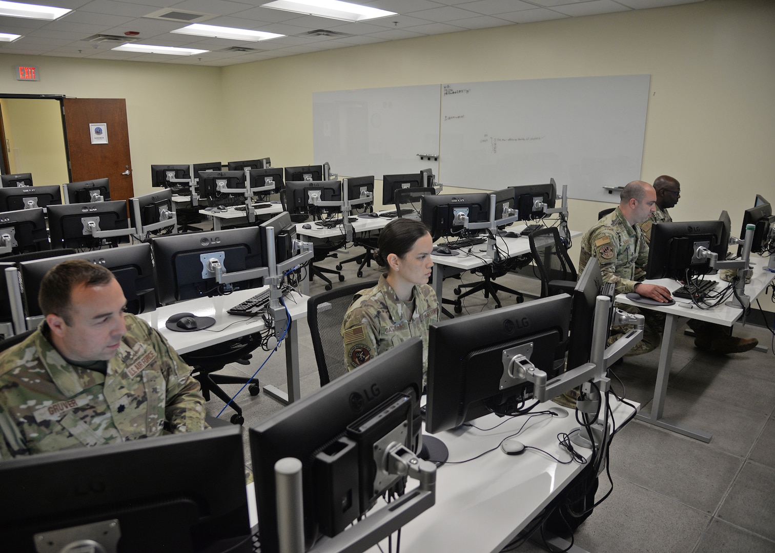 Airmen assigned to the 175th Cyberspace Operations Group work at computer terminals at Martin State Air National Guard Base, Middle River, Maryland, June 20, 2023. The Airmen are assisting with Project Vormsi, collaborating with their Estonian partners to build an information-sharing platform.