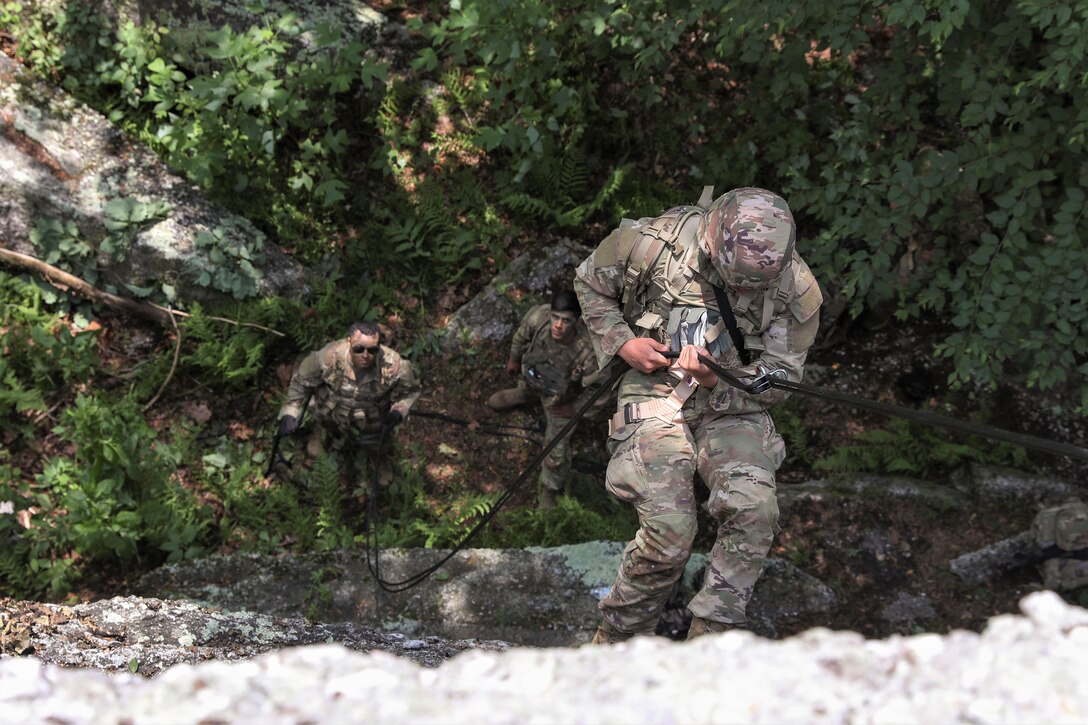 Approximately 25 Soldiers with 1st Squadron, 104th Cavalry Regiment, 2nd Infantry Brigade Combat team, 28th Infantry Division, Pennsylvania Army National Guard, conducted rappel training June 13 at a rock formation near Fort Indiantown Gap known as Boxcar Rocks. The Soldiers used mountain warfare skills to ascend the north face of the Boxcar Rocks safely with harnesses and ropes, then rappelled down the south face approximately 100 feet. (U.S. Army National Guard photo by Sgt. 1st Class Zane Craig)