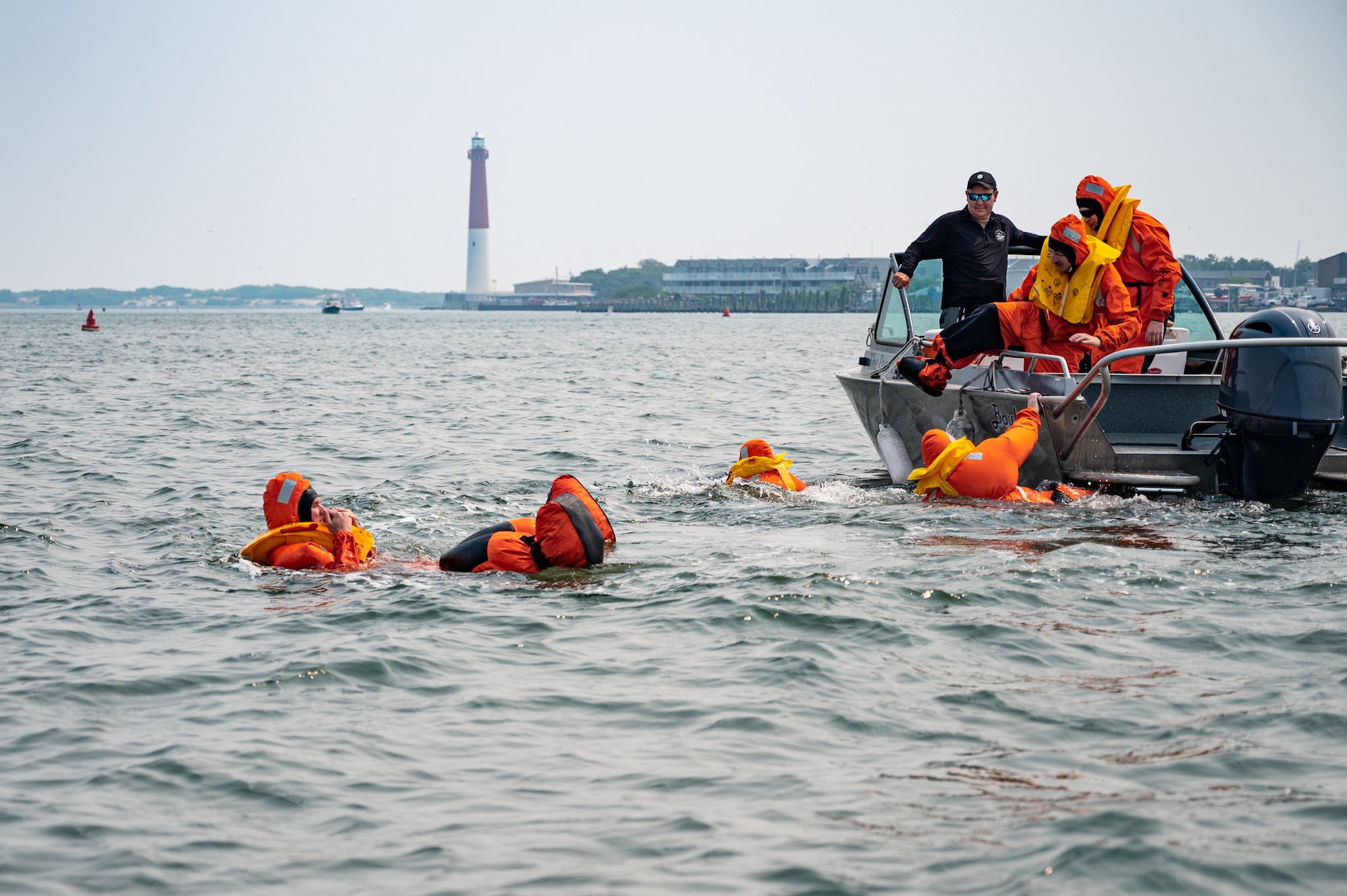 Royal Australian Air Force, Canadian Air Force, and U.S. Air Force aviators participate in a Survival, Evasion, Resistance and Escape water survival training course at Barnegat Light, N.J., June 6, 2023. SERE personnel from Joint Base McGuire-Dix-Lakehurst partnered with Coast Guard Air Station Atlantic City, N.J., to provide aircrew with realistic scenarios where flight crews must work together in order to survive a potential aircraft crash in the ocean. Exercises like these help build interoperability and standardized training capabilities throughout different service branches and our allied partners.