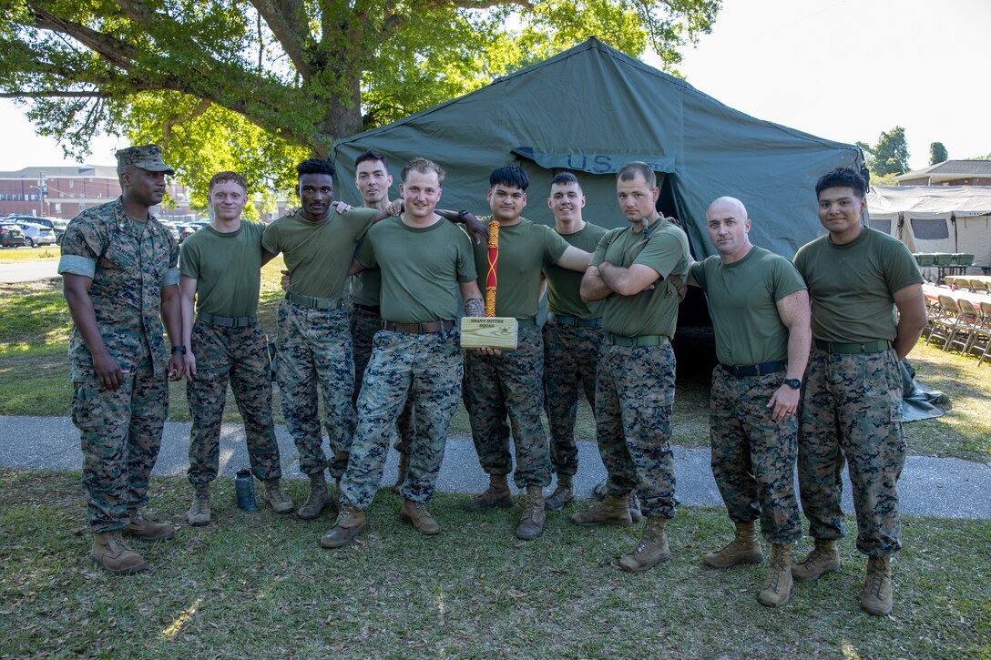 U.S Marines Corps with II Marine Expeditionary Force Support Battalion, Squad Competition winners pose for a group photo aboard Marine Corps Base Camp Lejeune, North Carolina, April 14, 2023. The Squad Competition with II MSB executed the battalion field exercise to maintain combat readiness and to show capabilities in a simulated deployed environment. (U.S. Marine Corps photo by Cpl. Marc Imprevert)