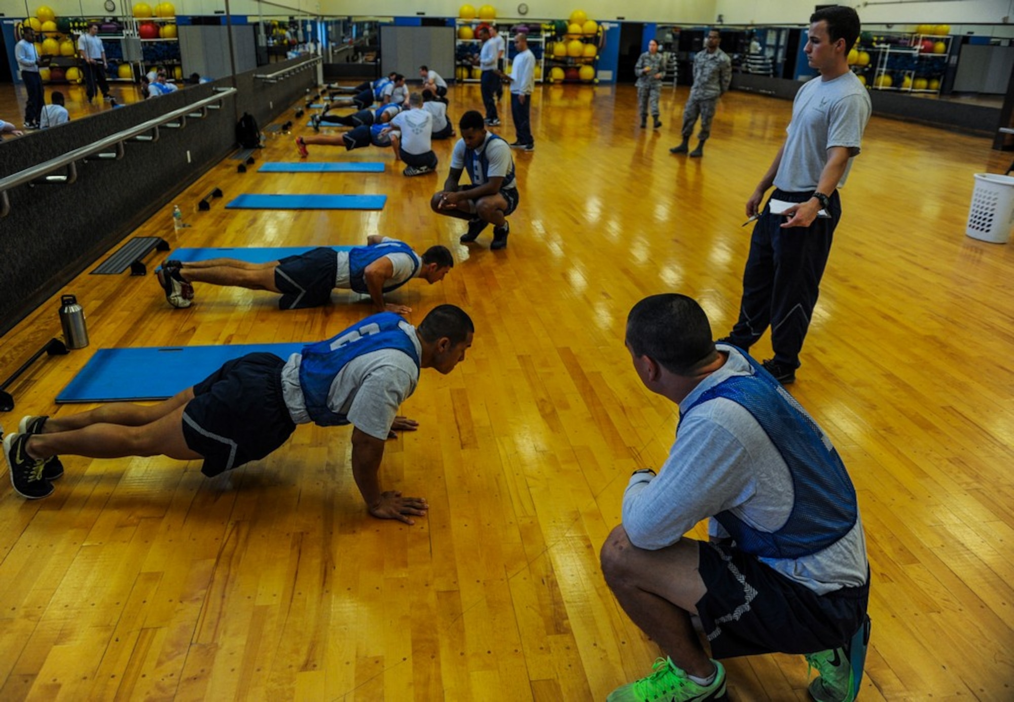U.S. Air Force Airmen perform the push up portion of the physical fitness test, Dec. 1, 2016, at the Risner Fitness Center on Kadena Air Base, Japan. Proper physical fitness is an integral part of the fit-to-fight mentality as well as part of a healthy lifestyle.