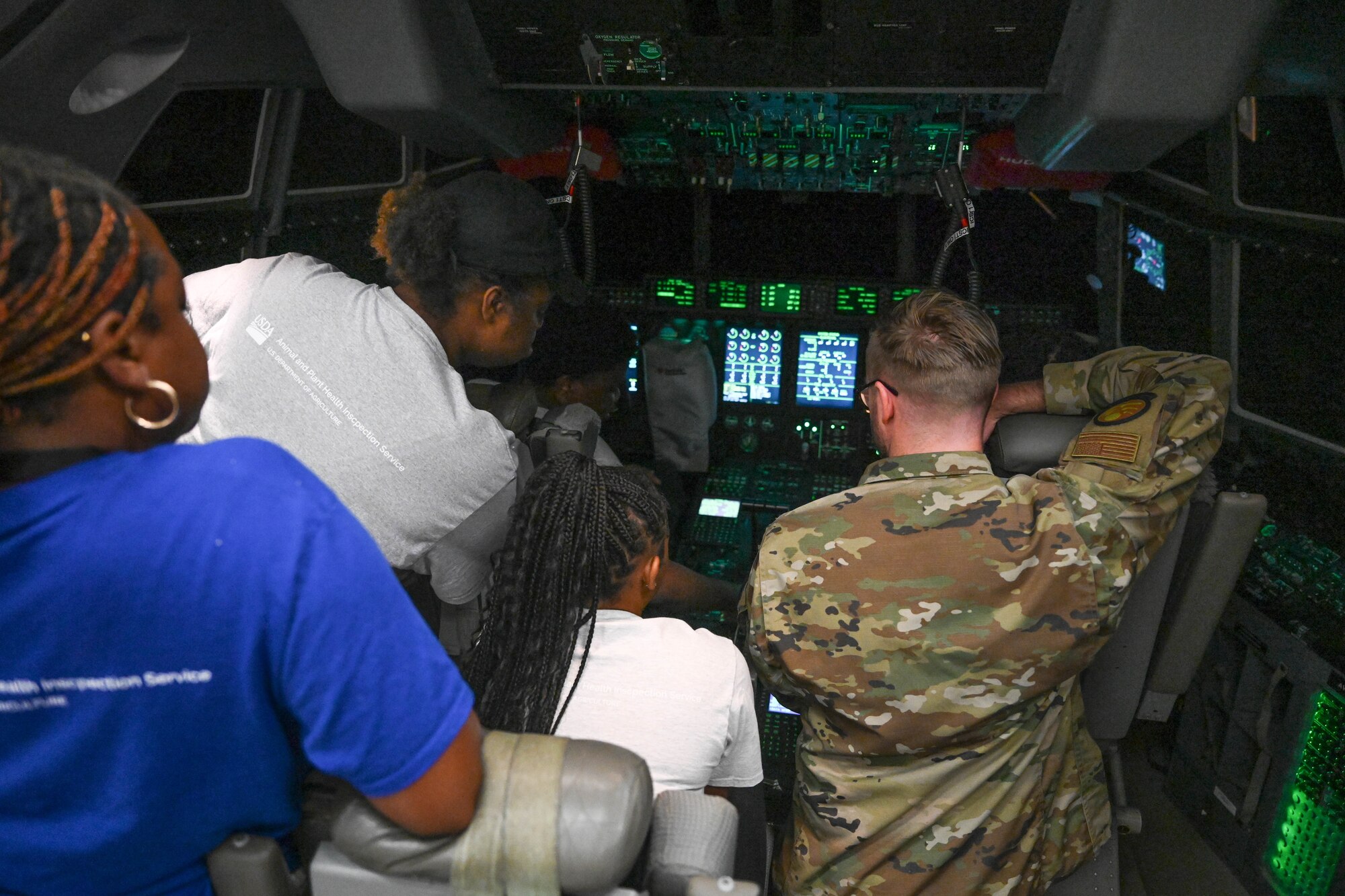 Teenagers sit in a cockpit