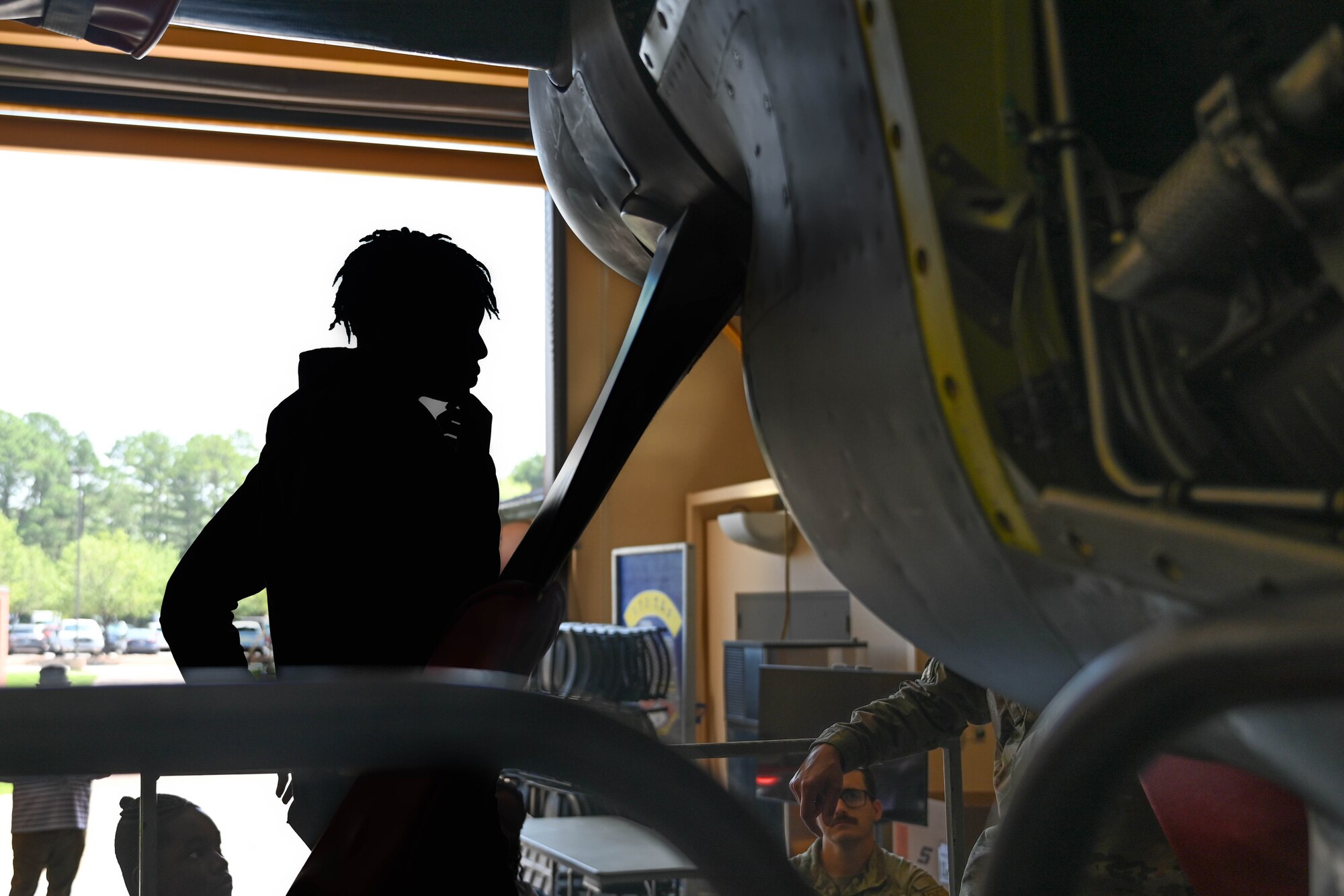 A teenager looks at an engine