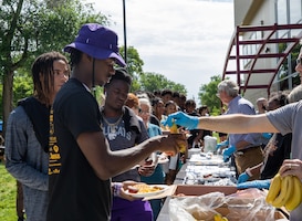 Residents of the Flint Hills region receive food during the 4-day Juneteenth celebration in Manhattan, Kansas, June 17, 2023. Manhattan hosted a 4-day celebration, where they had food, games, live music and various other activities. (U.S. Army photo by Pvt. Autumn Johnson)