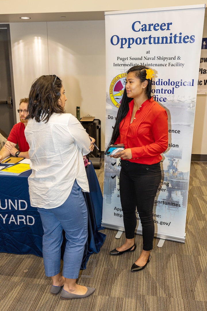 Tiera Beauchamp, right, president, International Federation of Professional and Technical Engineers Local 12, offers advice to a job applicant June 6, 2023, during the Puget Sound Naval Shipyard & Intermediate Maintenance Facility Hiring Fair at the Kitsap Conference Center in Bremerton, Washington. Approximately 1,600 local job seekers attended the two-day event. (U.S. Navy photo by Jeb Fach)