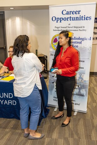 Tiera Beauchamp, right, president, International Federation of Professional and Technical Engineers Local 12, offers advice to a job applicant June 6, 2023, during the Puget Sound Naval Shipyard & Intermediate Maintenance Facility Hiring Fair at the Kitsap Conference Center in Bremerton, Washington. Approximately 1,600 local job seekers attended the two-day event. (U.S. Navy photo by Jeb Fach)