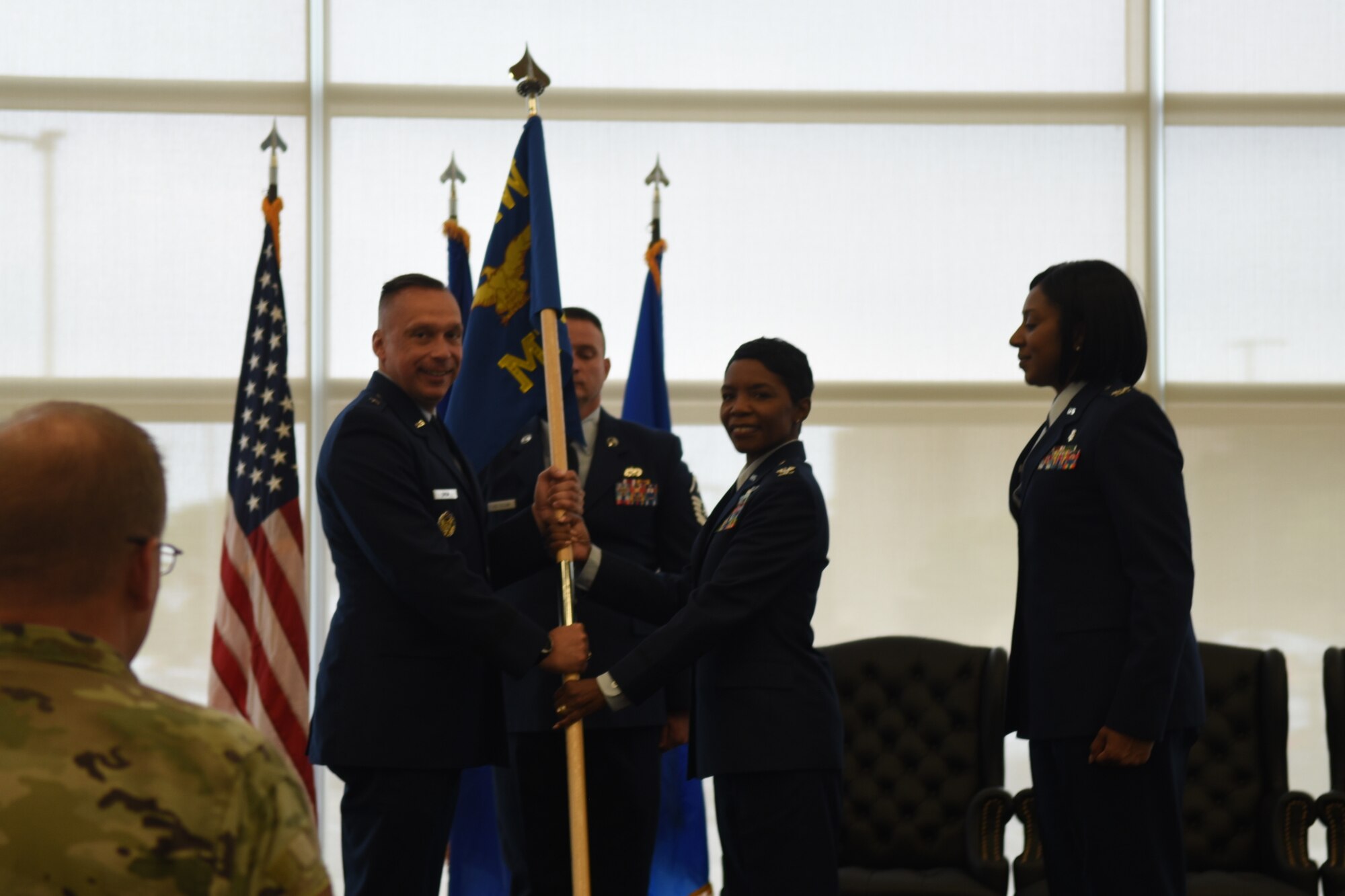 Brigadier General Lyle Drew and Colonel Sarah Evans hold the guidon at her change of command ceremony. Colonel Evans replaced Colonel Felicia Burks on June 21st, 2023 at the Sheppard Clinic as the 82d Medical Group Commander. (U.S. Air Force photo by Second Lieutenant Lauren Niemi)