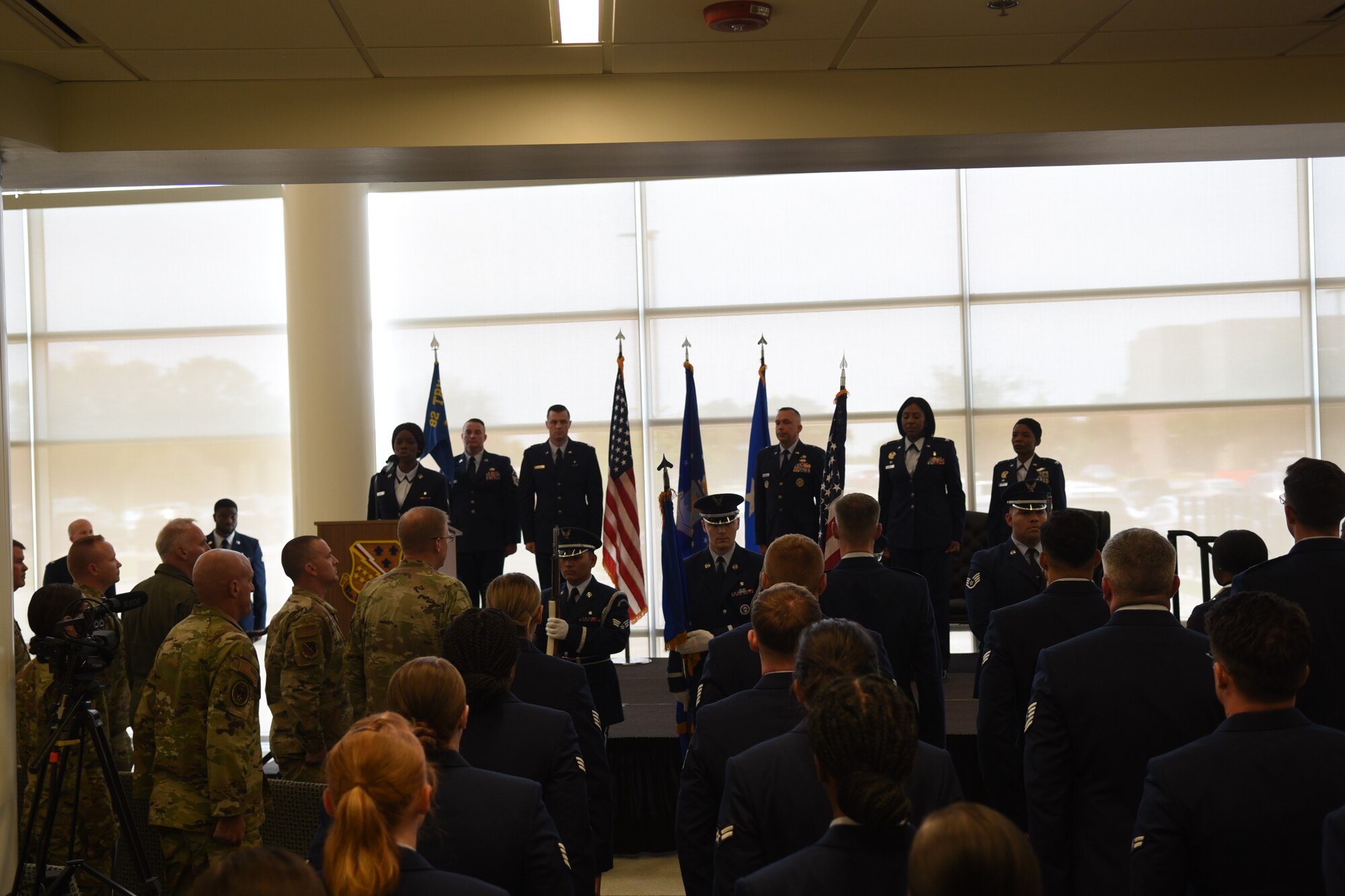 The official party stands on stage during the national anthem before the 82d Medical Group change of command. Colonel Sarah Evans replaced Colonel Felicia Burks on June 21st, 2023 at the Sheppard Clinic as the 82d Medical Group Commander. (U.S. Air Force photo by Second Lieutenant Lauren Niemi)