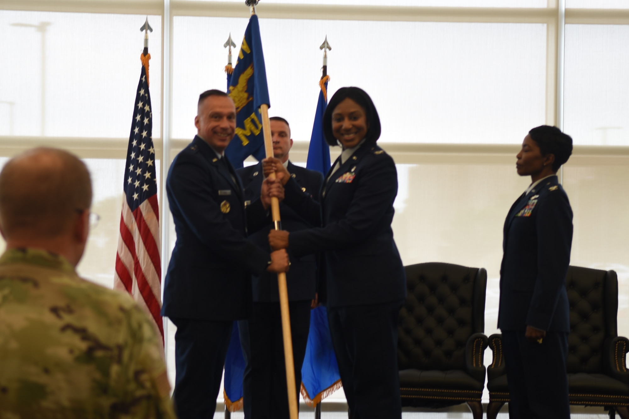 Brigadier General Lyle Drew and Colonel Felicia Burks hold the guidon at her change of command ceremony. Colonel Sarah Evans replaced Colonel Burks on June 21st, 2023 at the Sheppard Clinic as the 82d Medical Group Commander. (U.S. Air Force photo by Second Lieutenant Lauren Niemi)