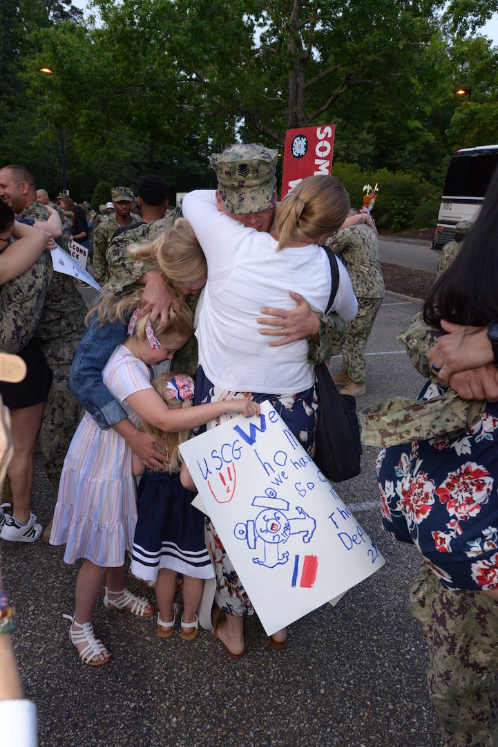 Petty Officer 1st Class Nathan Jones, a maritime law enforcement specialist with Port Security (PSU) 305, embraces his family in Williamsburg, Va. after returning home from a nine-month deployment to Naval Station Guantanamo Bay, Cuba, June 15, 2023.

PSU 305, based in Fort Eustis, Va., was the first unit in 2002 to begin the Coast Guard’s mission with Joint Task Force Guantanamo Bay and is the last to complete it.

(U.S. Coast Guard photo by Petty Officer 1st Class Valerie Higdon)