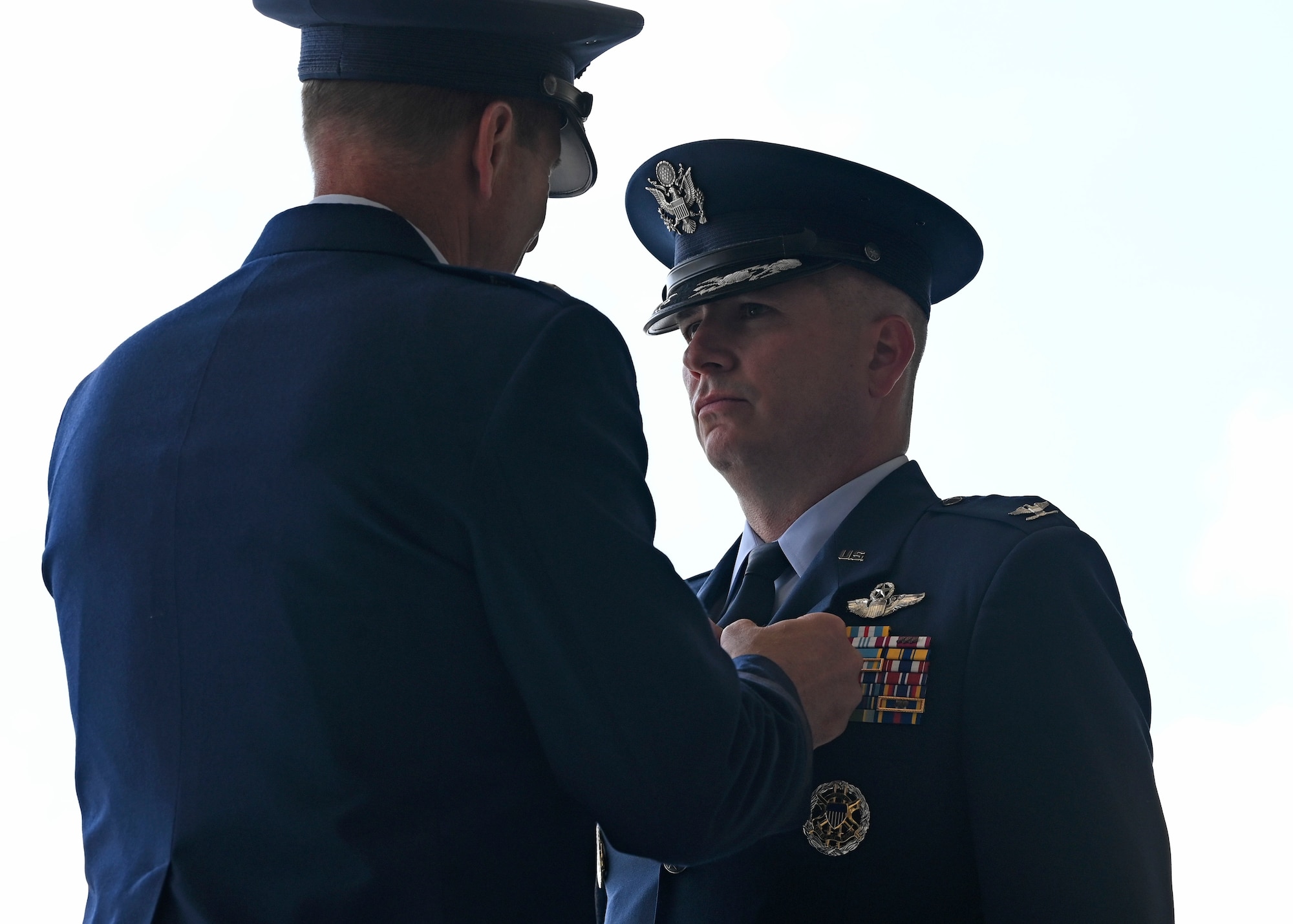 U.S. Air Force Col. David Fazenbaker, right, outgoing commander of the 62d Airlift Wing, receives the Legion of Merit from Maj. Gen. Corey Martin, 18th Air Force commander, during a change of command ceremony at Joint Base Lewis-McChord, Washington, June 21, 2023. The 62d AW’s mission is to execute global airlift, prepare for Joint and Coalition Multi-Domain Operations in near-peer contested environments, and continually ensure Force Development. (U.S. Air Force photo by Senior Airman Callie Norton)