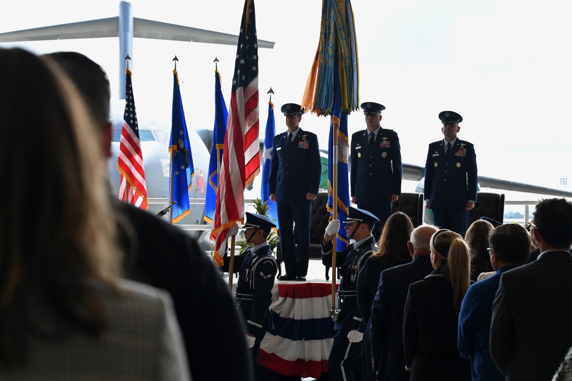 (From left) U.S. Air Force Maj. Gen. Corey Martin, 18th Air Force commander, Col. David Fazenbaker, outgoing 62d Airlift Wing commander, and Col. Sergio Anaya, incoming 62d AW commander, prepare to salute the flag during the presentation of colors at the 62d AW change of command ceremony at Joint Base Lewis-McChord, Washington, June 21, 2023. The 62d AW’s mission is to execute global airlift, prepare for Joint and Coalition Multi-Domain Operations in near-peer contested environments, and continually ensure Force Development. (U.S. Air Force photo by Senior Airman Colleen Anthony)