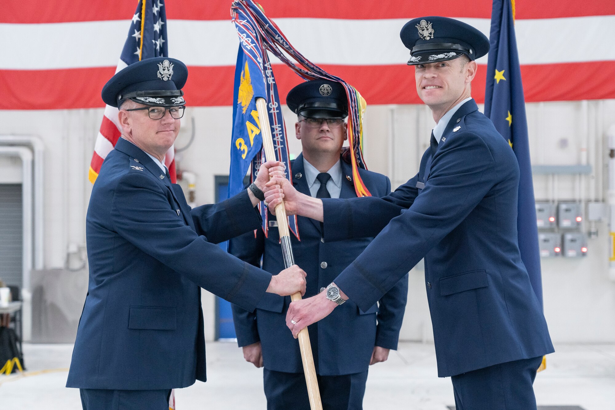 A photo of Col. Christopher Tooman receiving guidon from Lt. Col. Timothy Doster.