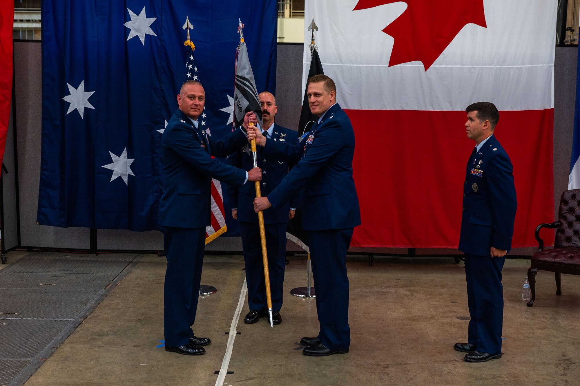 U.S. Space Force Col. Marc A. Brock, Space Delta 2 commander, left, holds the 18th Space Defense Squadron (18 SDS) guidon with outgoing 18 SDS Lt. Col. Matthew J. Lintker during the squadron’s change of command ceremony at Vandenberg Space Force Base, Calif., June 21, 2023. The ceremonial exchanging of the guidon signifies Lintker relinquishing his command of the 18 SDS over to Brock who then transferred the responsibility to U.S. Space Force Lt. Col. Jordan O.E. Mugg, the incoming 18 SDS commander. (U.S. Space Force photo by Tech. Sgt. Luke Kitterman)