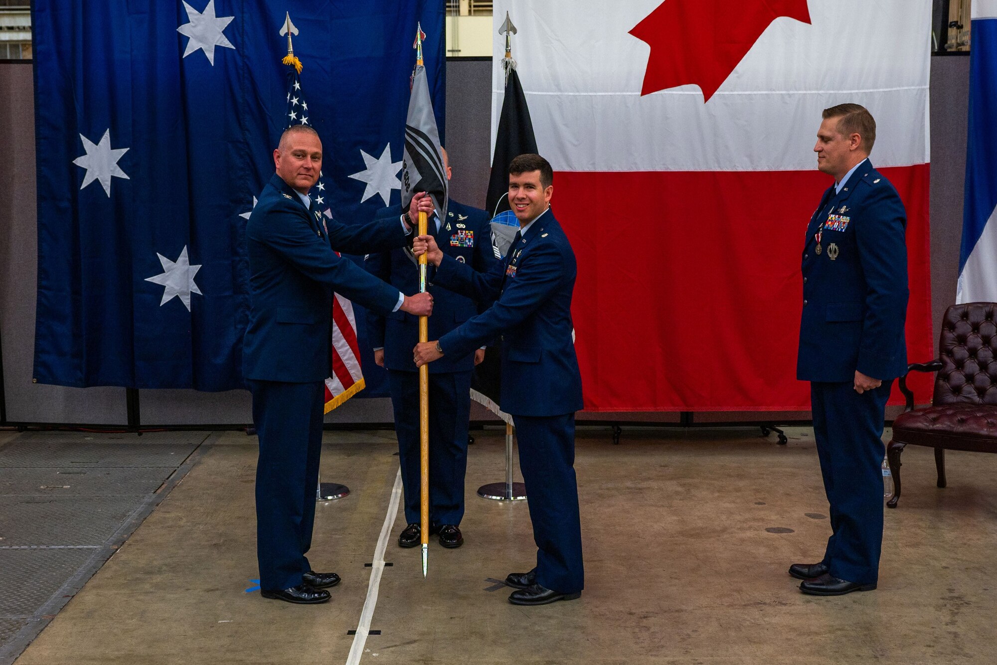 U.S. Space Force Col. Marc A. Brock, Space Delta 2 commander, left, holds the 18th Space Defense Squadron (18 SDS) guidon with incoming 18 SDS commander Lt. Col. Jordan O.E. Muggduring the 18 SDS change of command ceremony at Vandenberg Space Force Base, Calif., June 21, 2023. The ceremonial exchanging of the guidon signifies U.S. Space Force Lt. Col. Matthew J. Lintker, outgoing 18 SDS commander, relinquishing his command of the 18 SDS over to Brock who then transferred the responsibility to Mugg. (U.S. Space Force photo by Tech. Sgt. Luke Kitterman)