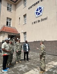 Lt. Col. Eugene Chu, the 405th Army Field Support Brigade’s Corps Logistics Support Element senior representative, briefs representatives from the U.S. Navy and the Defense Logistics Agency outside the V Corps headquarters in Poznan, Poland, June 21. The CLSE serves as a strategic liaison among the U.S. Army Materiel Command enterprise, Department of Defense agencies, the 405th AFSB and V Corps. (U.S. Army courtesy photo)
